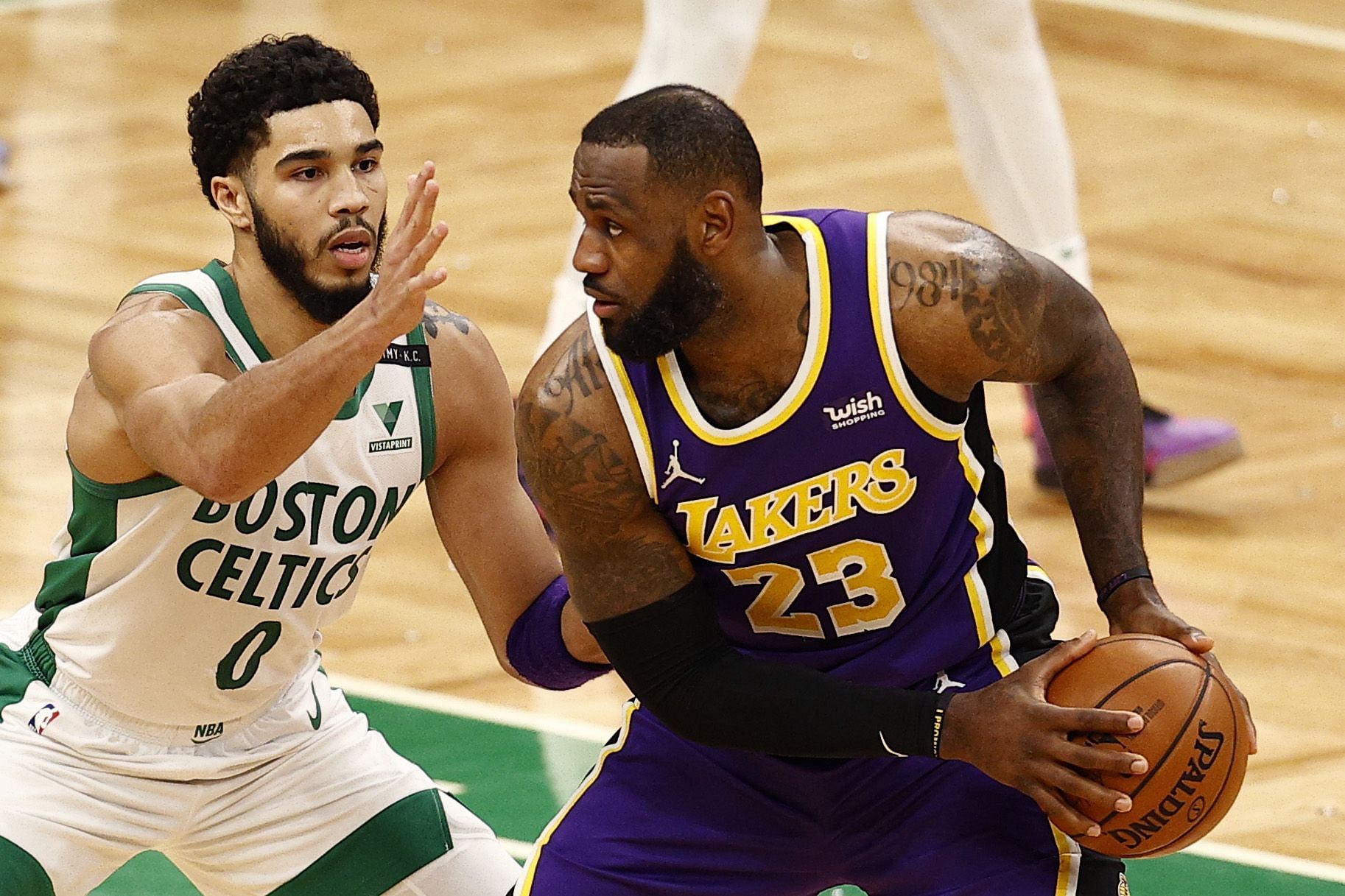 Jayson Tatum of the Boston Celtics defending LeBron James of the LA Lakers