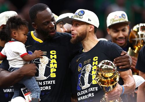 Steph Curry of the Golden State Warriors celebrates with Draymond Green and his daughter Kyla Green