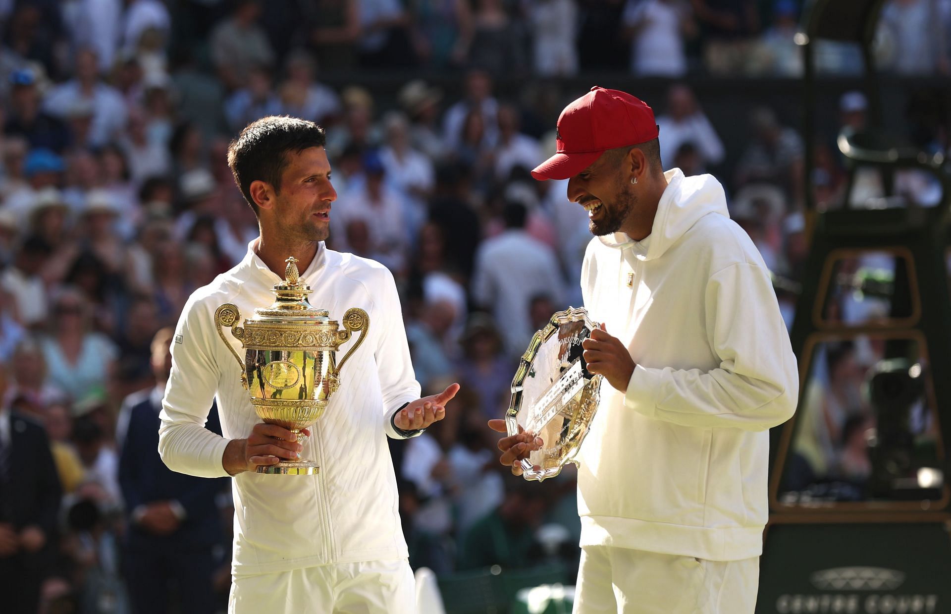 Novak Djokovic and Nick Kyrgios pose with their trophies at Wimbledon 2022