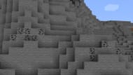 Many coal ore blocks generating on a small mountain (Image via Minecraft 1.19 update)