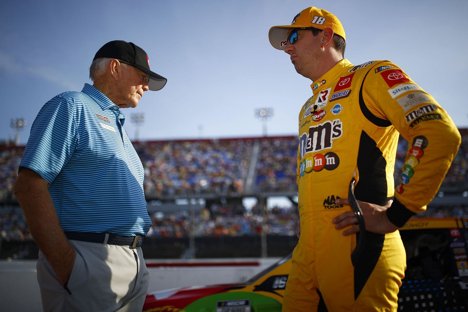 Kyle Busch and team owner Joe Gibbs talk on the grid before the NASCAR Cup Series Cook Out Southern 500 at Darlington Raceway (Photo by Jared C. Tilton/Getty Images)