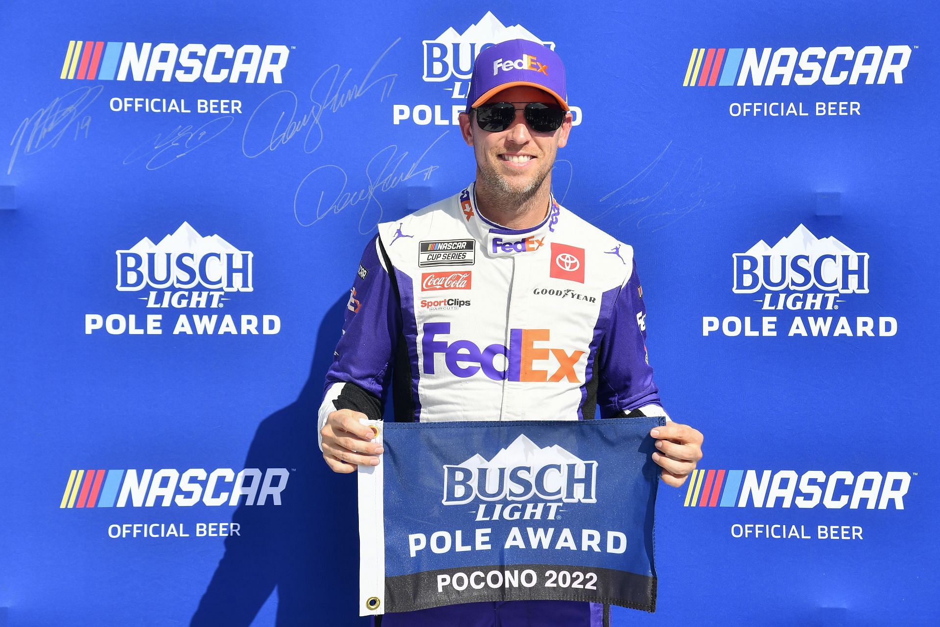 Denny Hamlin poses for photos after winning the pole award during qualifying for the NASCAR Cup Series M&amp;M&#039;s Fan Appreciation 400 at Pocono Raceway (Photo by Logan Riely/Getty Images)
