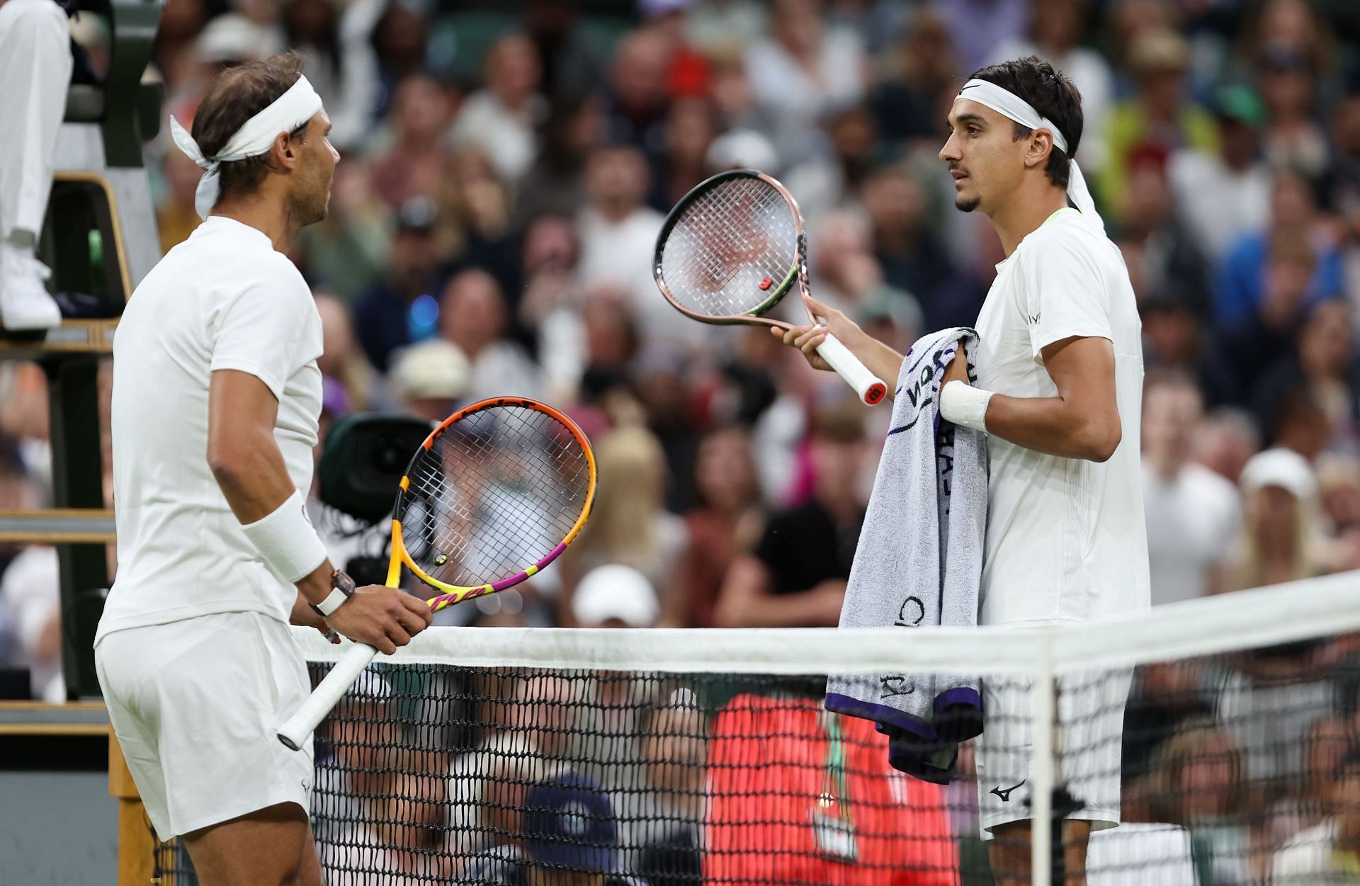Rafael Nadal and Lorenzo Sonego in discussion during their Wimbledon third round match.