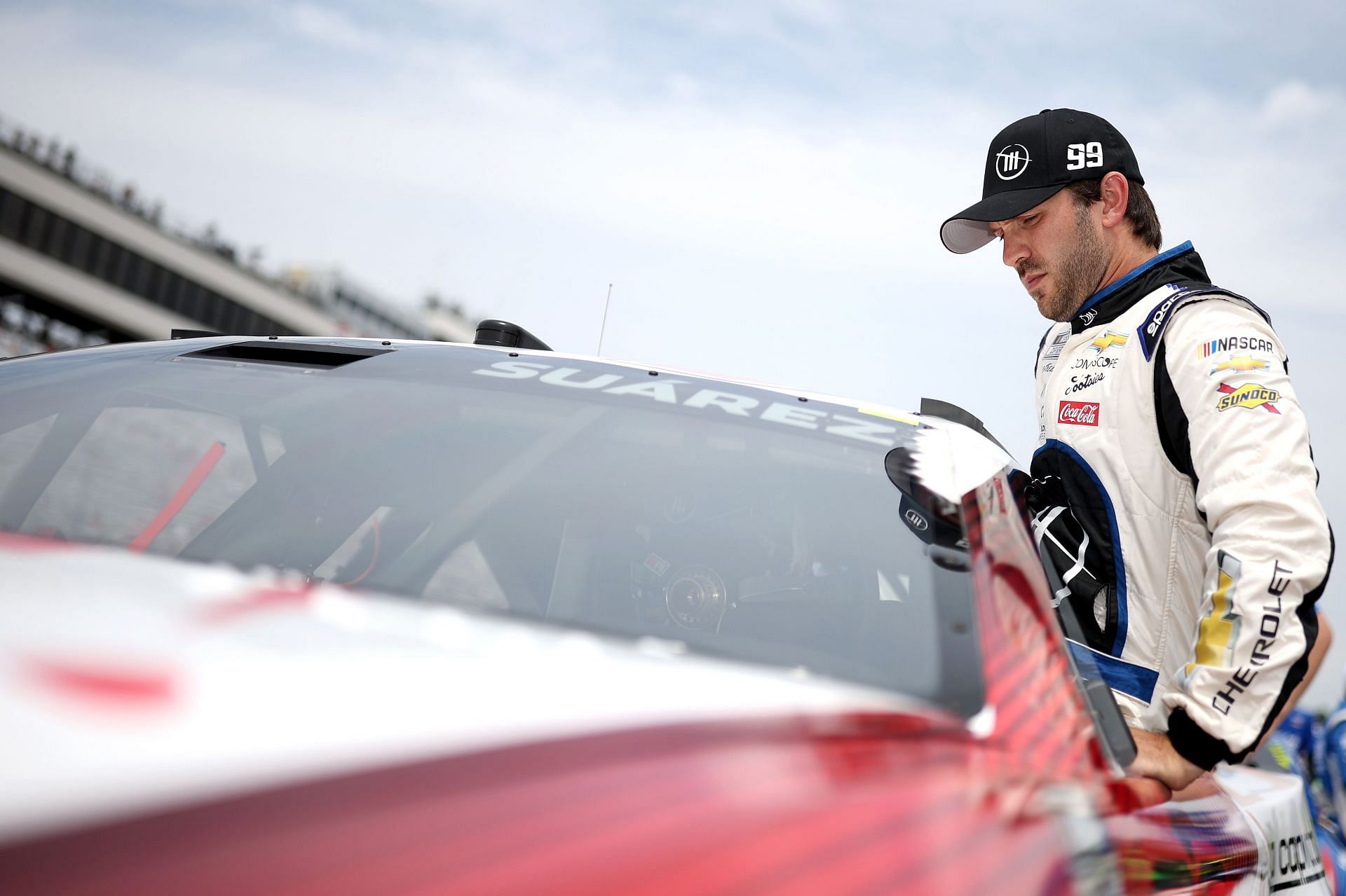 Daniel Suarez enters his car during qualifying for the NASCAR Cup Series Ambetter 301 at New Hampshire Motor Speedway in Loudon, New Hampshire (Photo by James Gilbert/Getty Images)