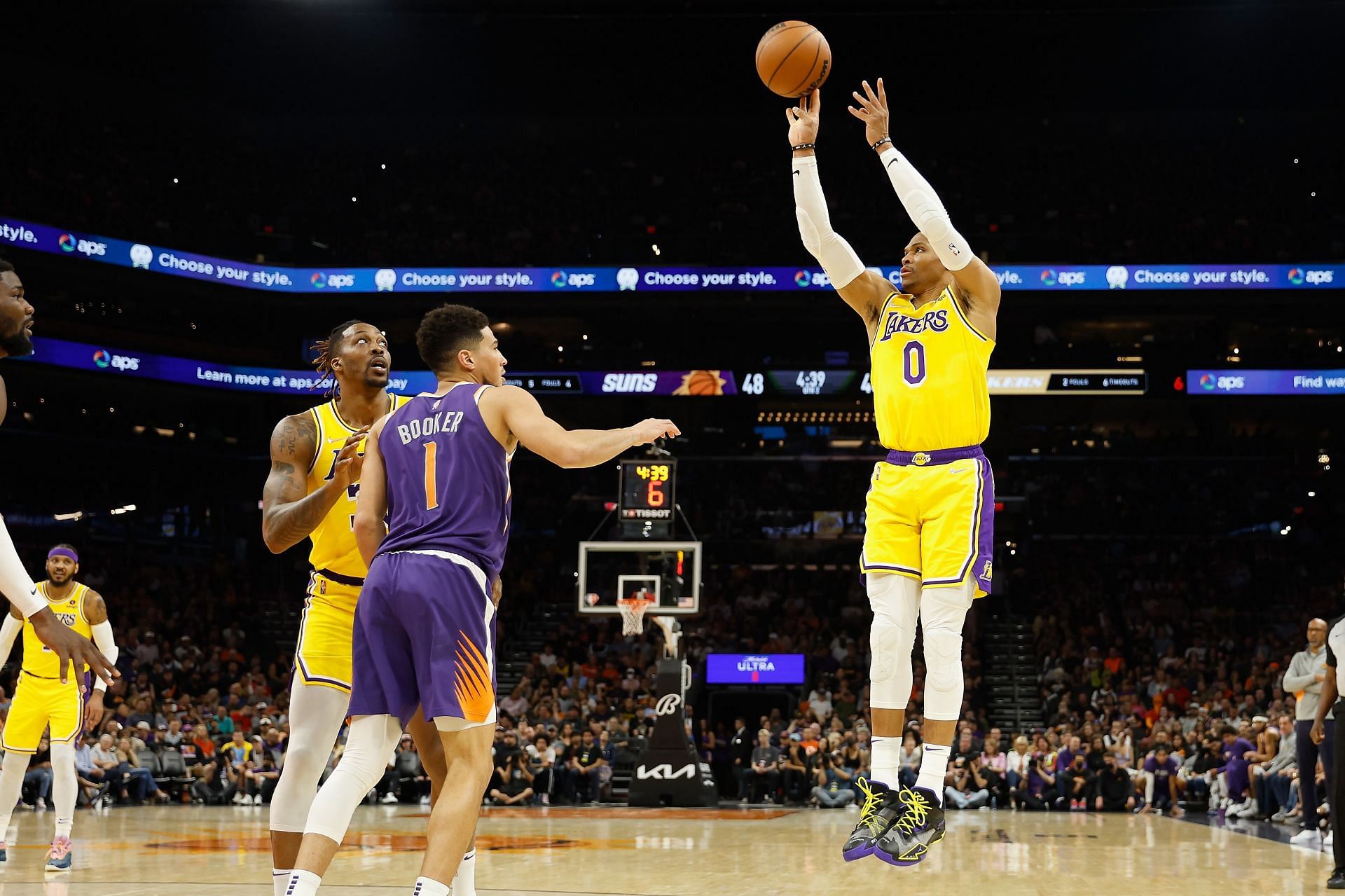 Russell Westbrook of the LA Lakers shoots over Devin Booker of the Phoenix Suns.