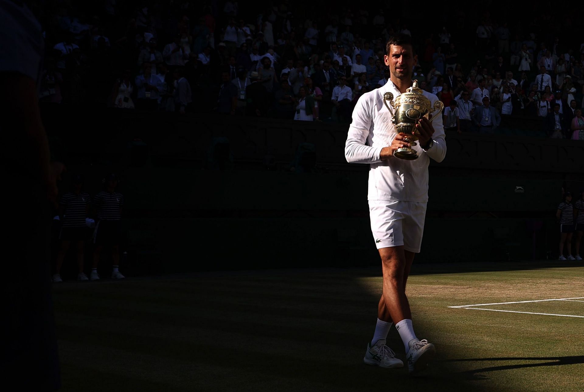 Novak Djokovic holds his fourth straight and seventh overall Wimbledon trophy.