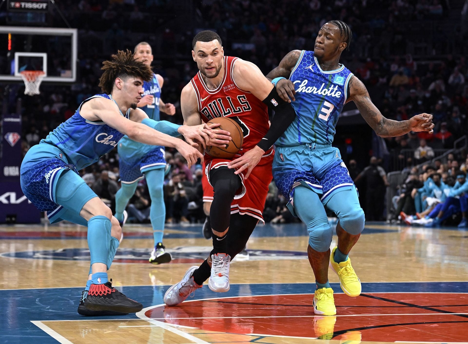 Zach LaVine of the Chicago Bulls drives between LaMelo Ball and Terry Rozier of the Charlotte Hornets