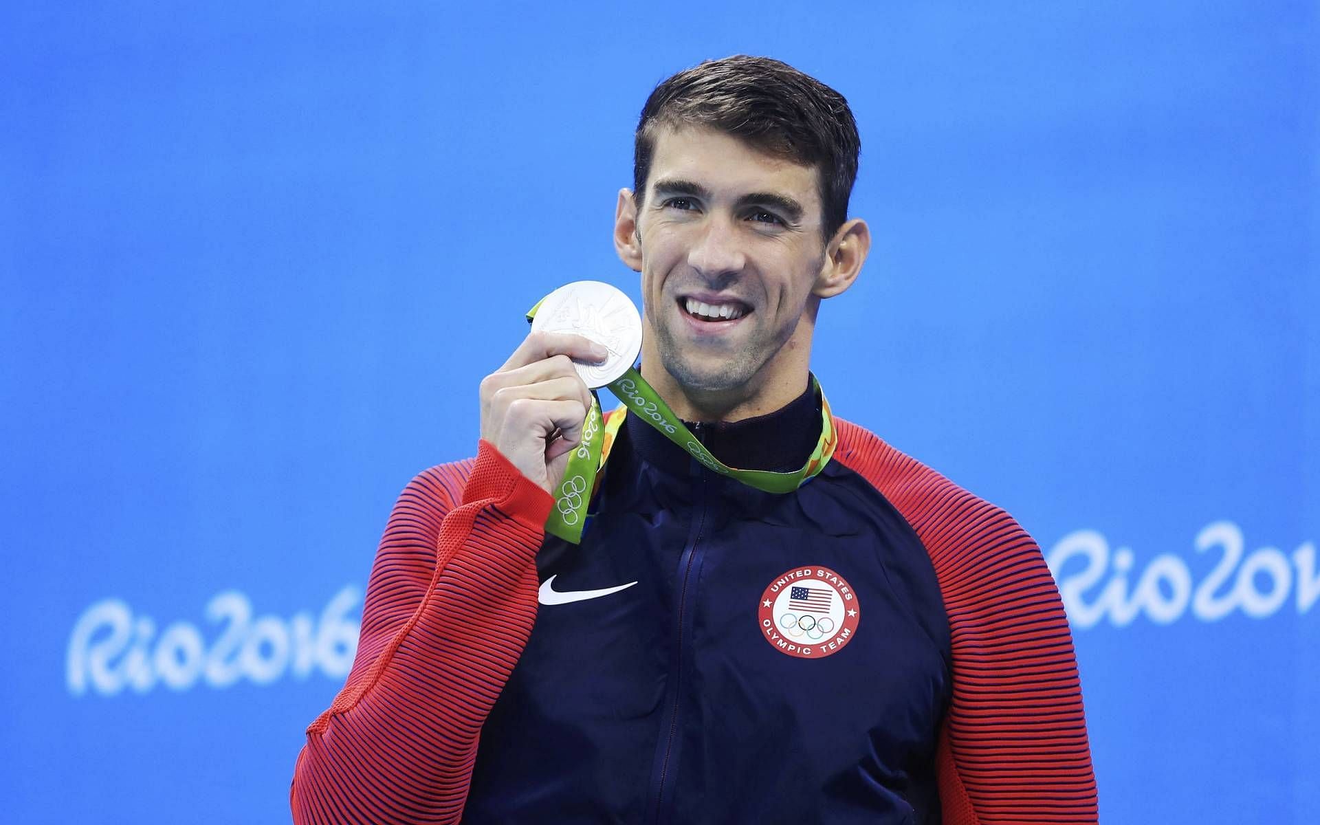 Michael Phelps with one of the medals that he won in the 2016 Summer Olympics (Image via Olympics)