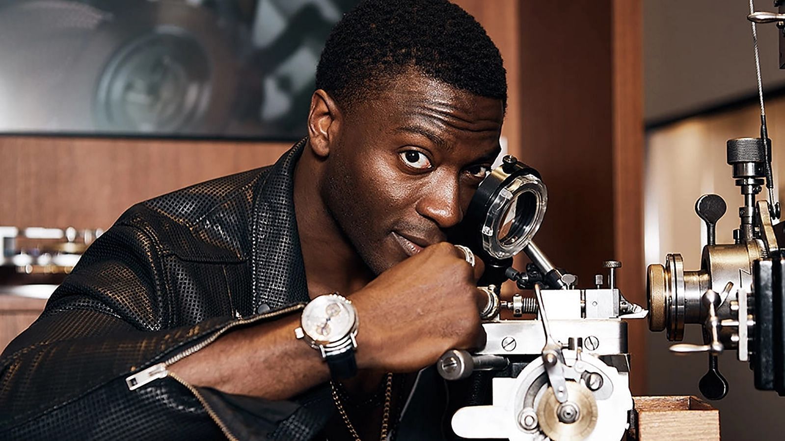 Aldis Hodge in front of his guilloche machine (Image via Kelsey Fain)