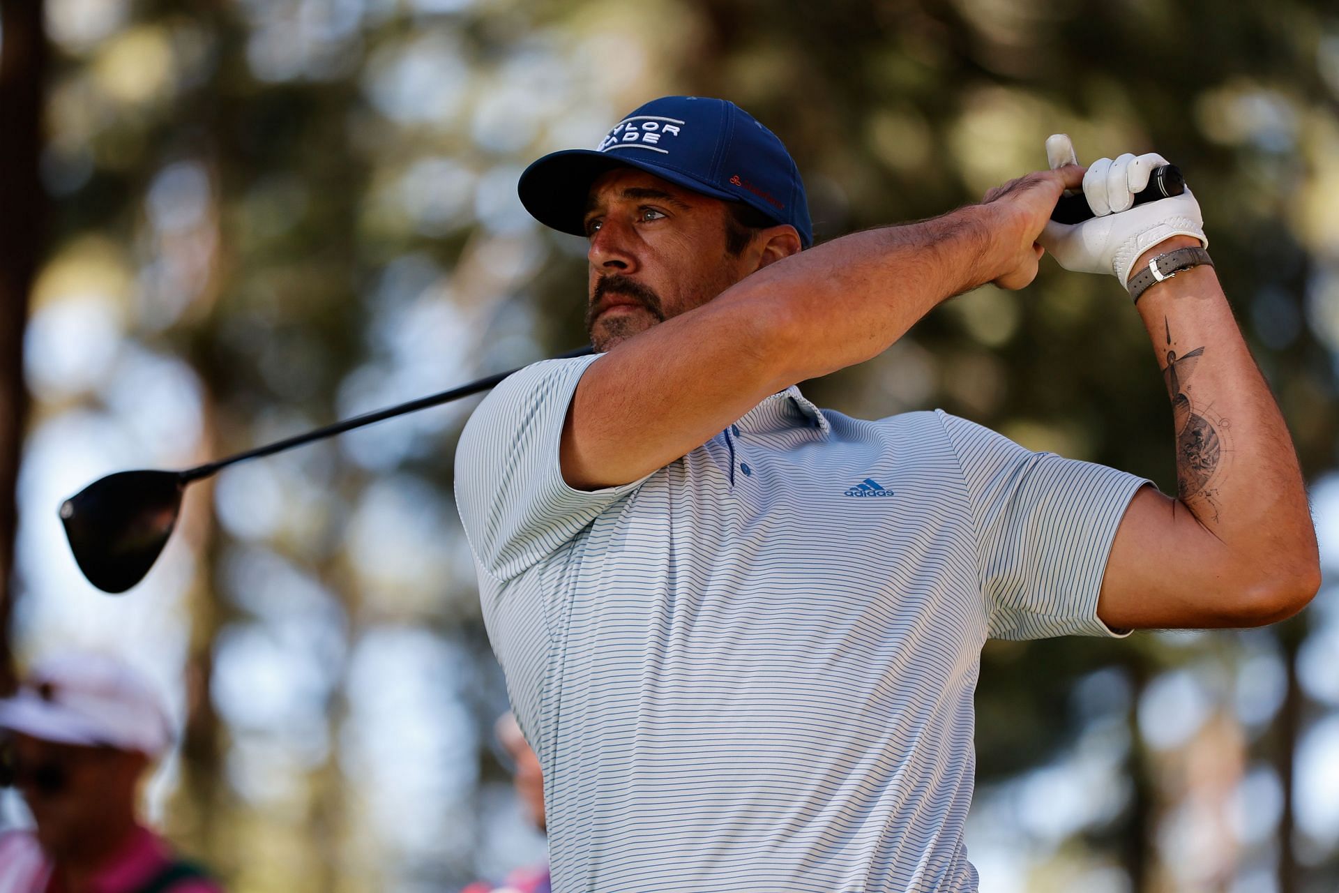 Aaron Rodgers playing in a golf tournament.