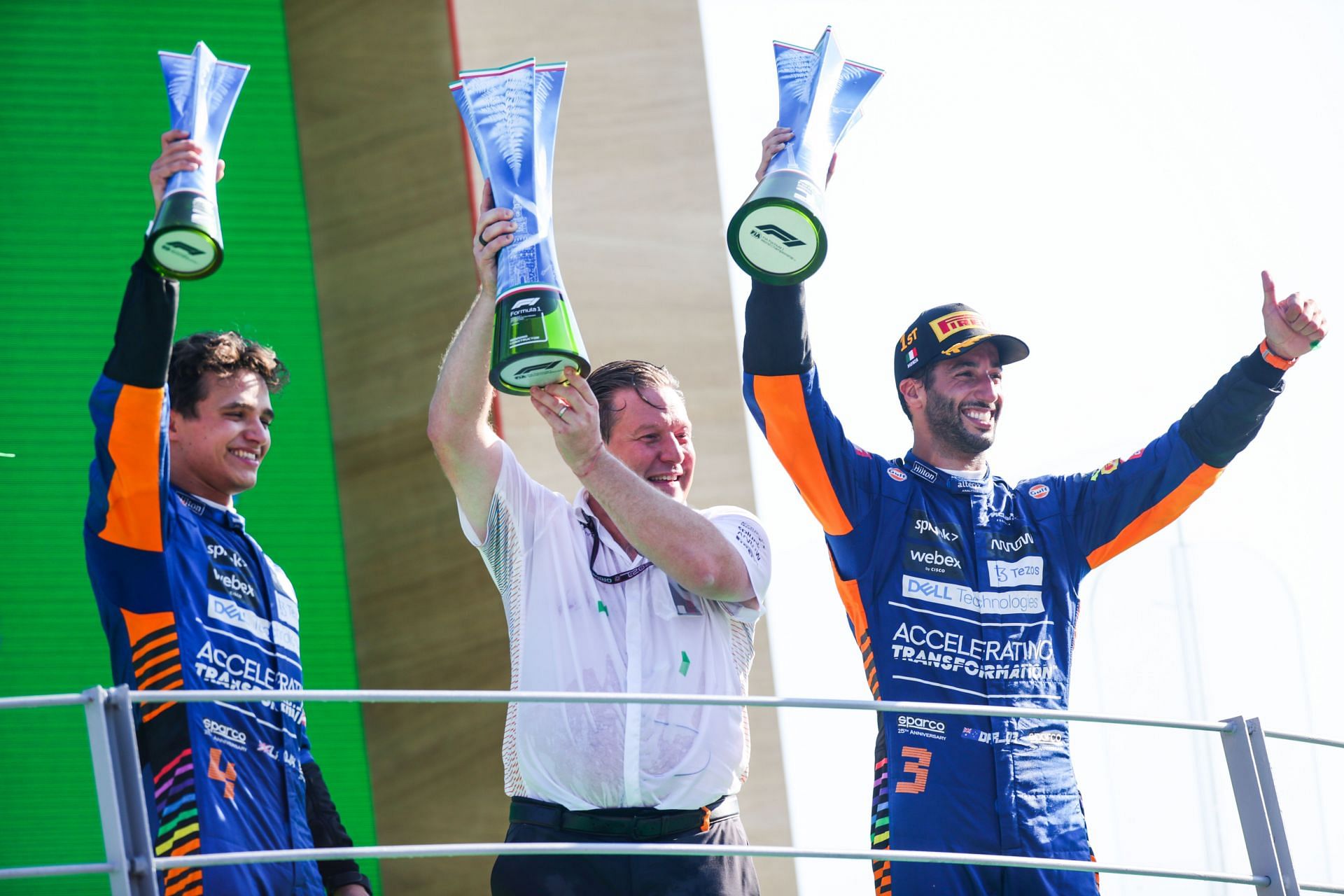 (From L to R) Lando Norris, Zak Brown, and Daniel Ricciardo celebrate McLaren&#039;s 1-2 finish at the 2021 F1 Italian GP (Photo by Peter Fox/Getty Images)