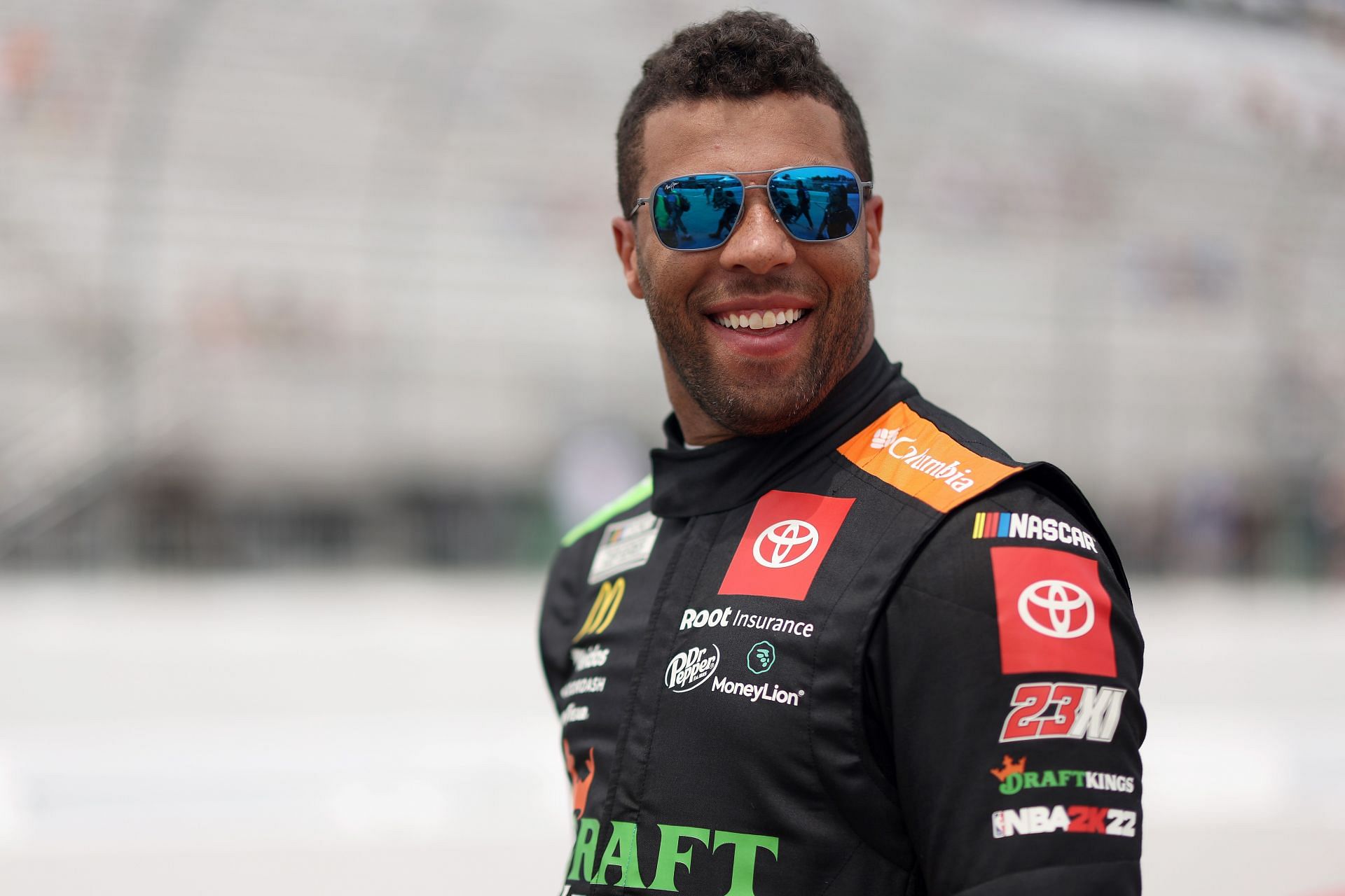 Bubba Wallace walks the grid during qualifying for the NASCAR Cup Series Ambetter 301 at New Hampshire Motor Speedway