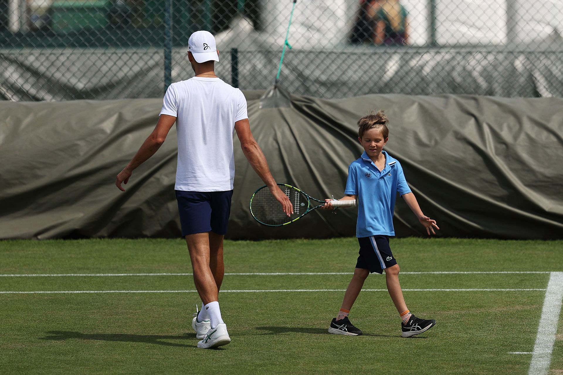 Novak Djokovic practising with his son Stefan during the 2022 Wimbledon Championships
