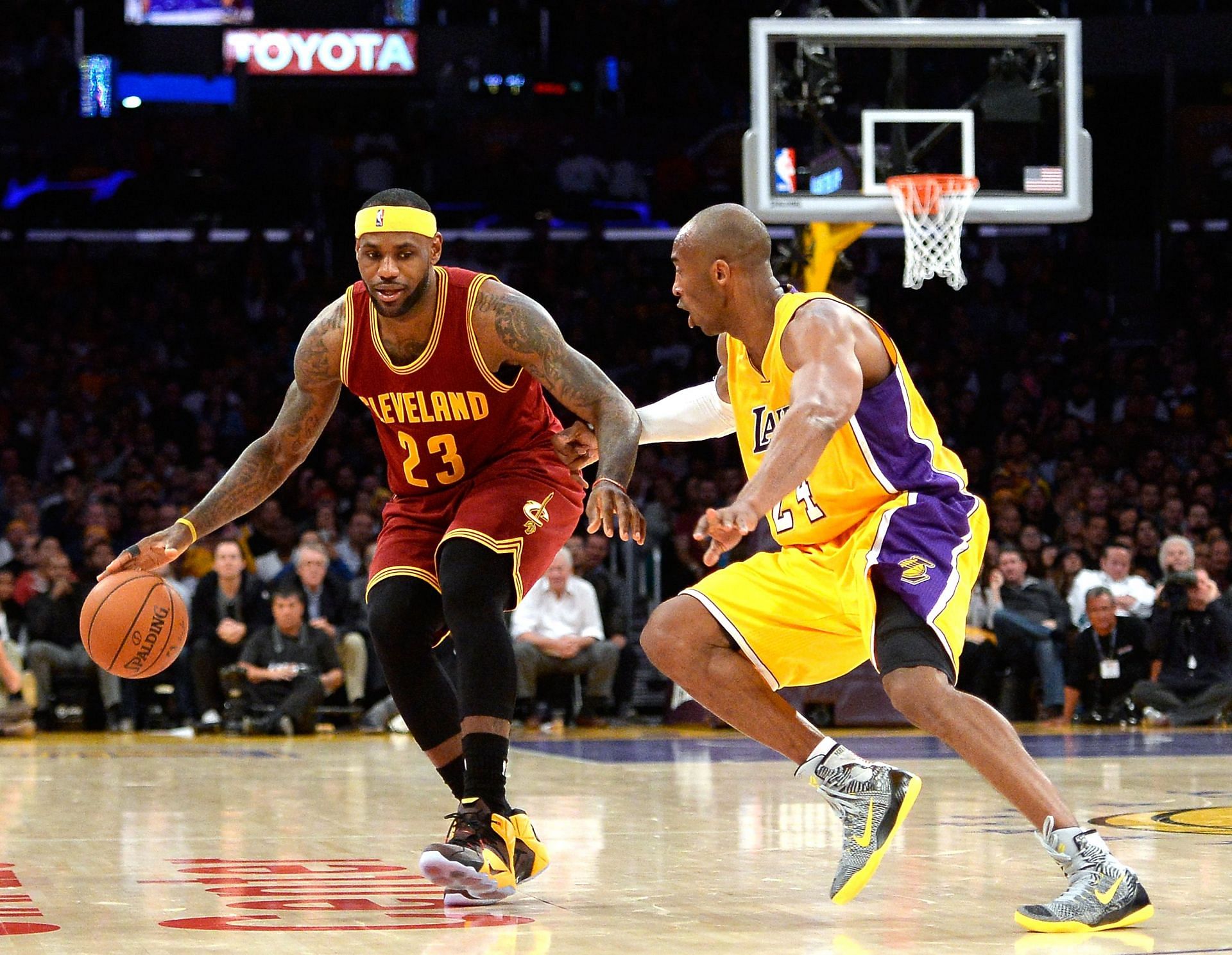 LeBron James #23 of the Cleveland Cavaliers dribbles as he is guarded by Kobe Bryant #24 of the Los Angeles Lakers during a 109-102 Cavalier win at Staples Center on January 15, 2015 in Los Angeles, California