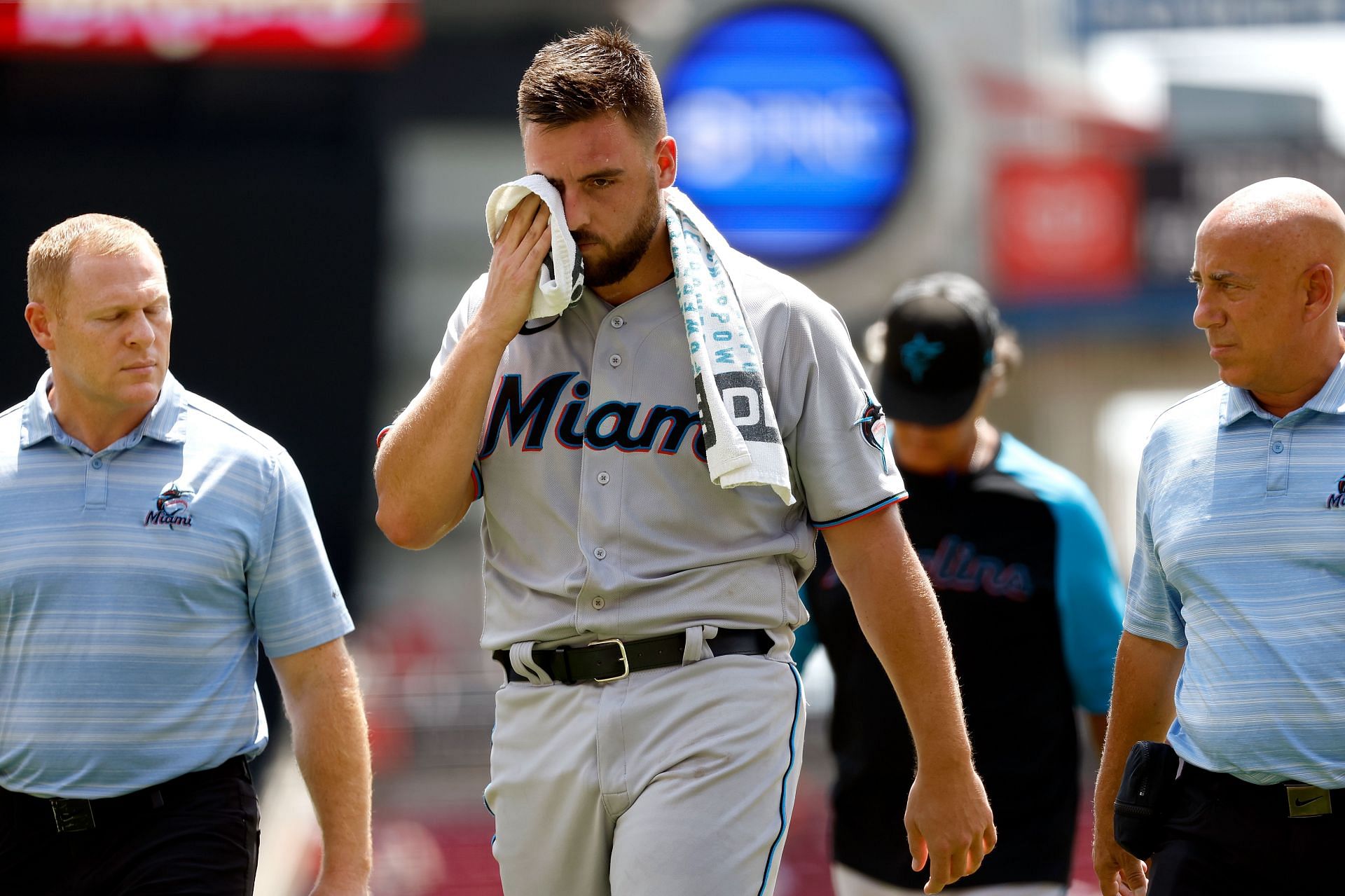 Daniel Castano of the Miami Marlins walks off of the field after being hit by a line drive in the head during the first inning of the game against the Cincinnati Reds at Great American Ball Park on July 28.