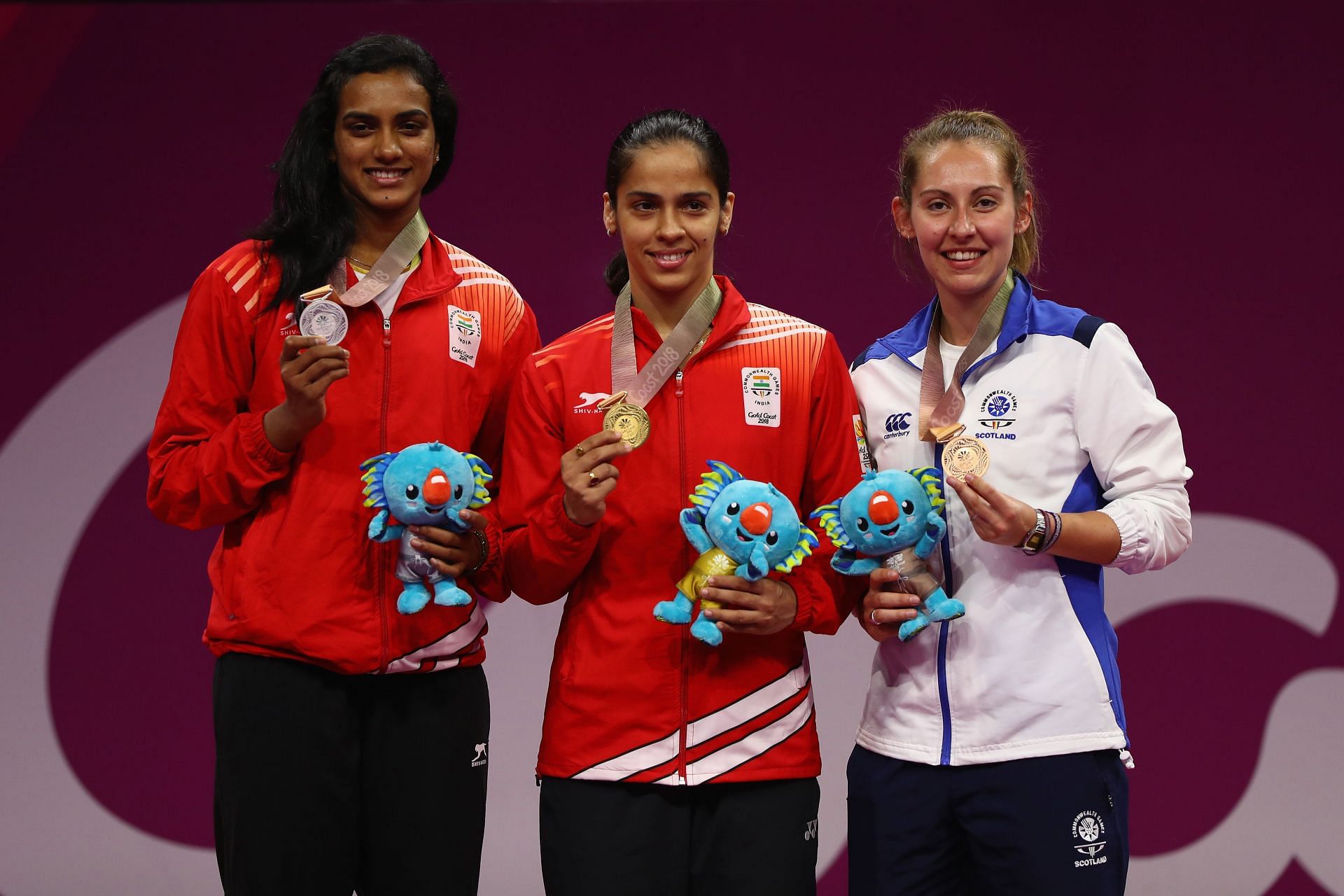 Gold medalist Saina Nehwal (C) poses with silver medalist PV Sindhu (L) and bronze medalist Kirsty Gilmour at the 2018 Commonwealth Games.