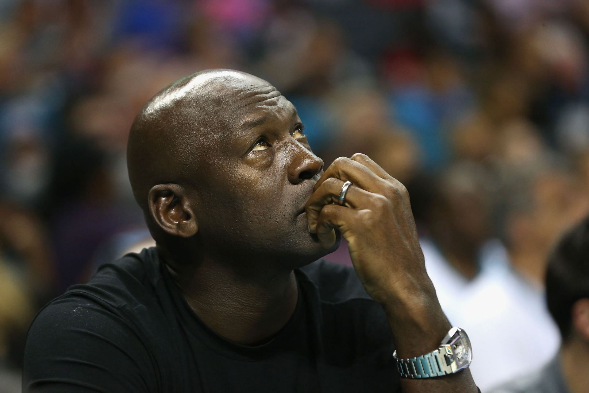 Michael Jordan looks on at a Charlotte Hornets game