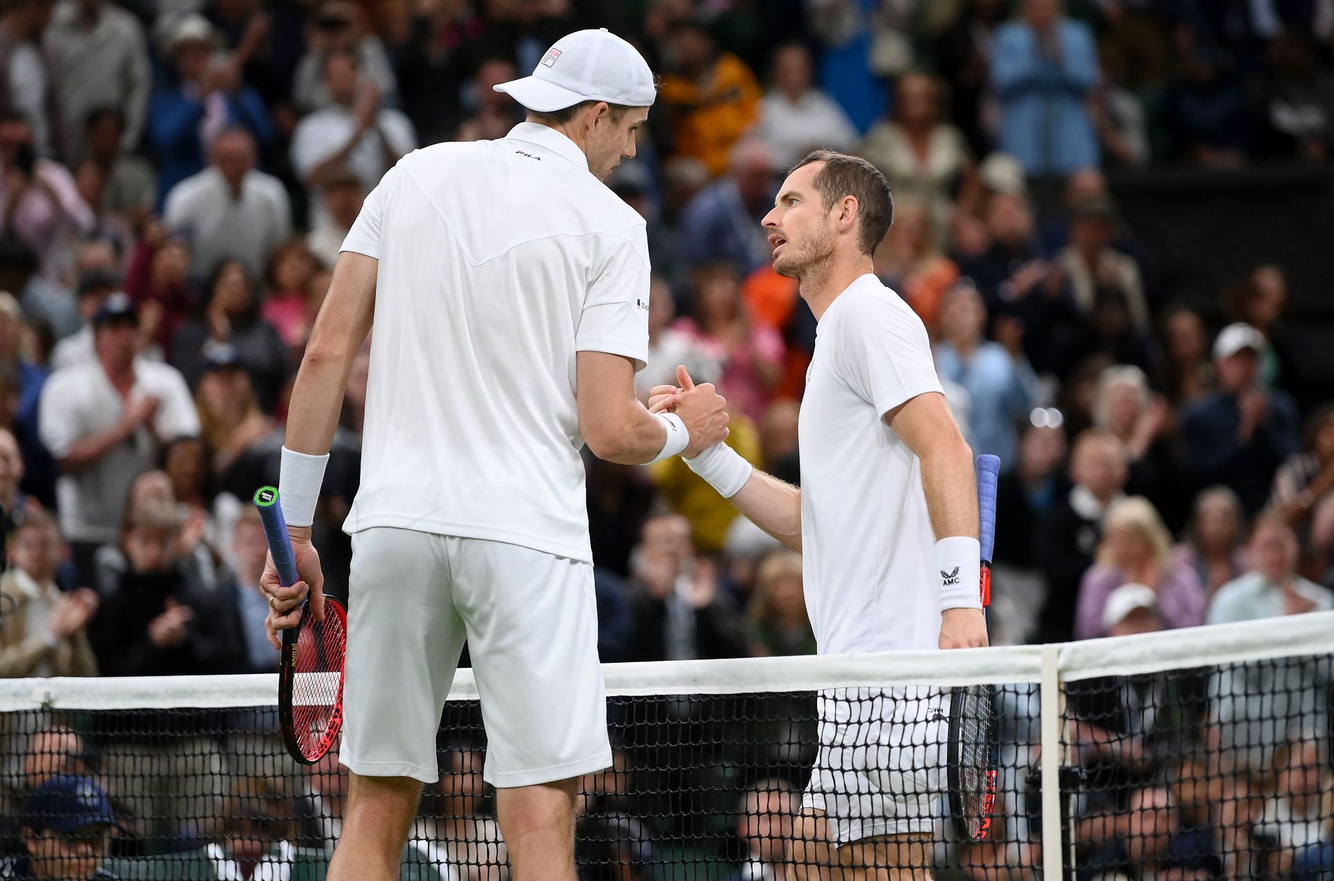 Andy Murray (R) and John Isner (L) at Wimbledon 2022