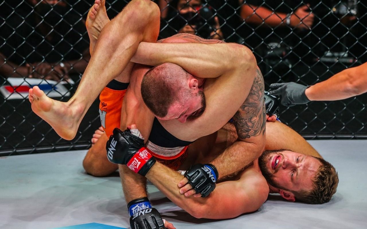 ONE double-champ Reinier de Ridder (bottom) submits Vitaly Bigdash via inverted triangle choke to retain his ONE middleweight world title in the main event of ONE 159. (Image courtesy of ONE)