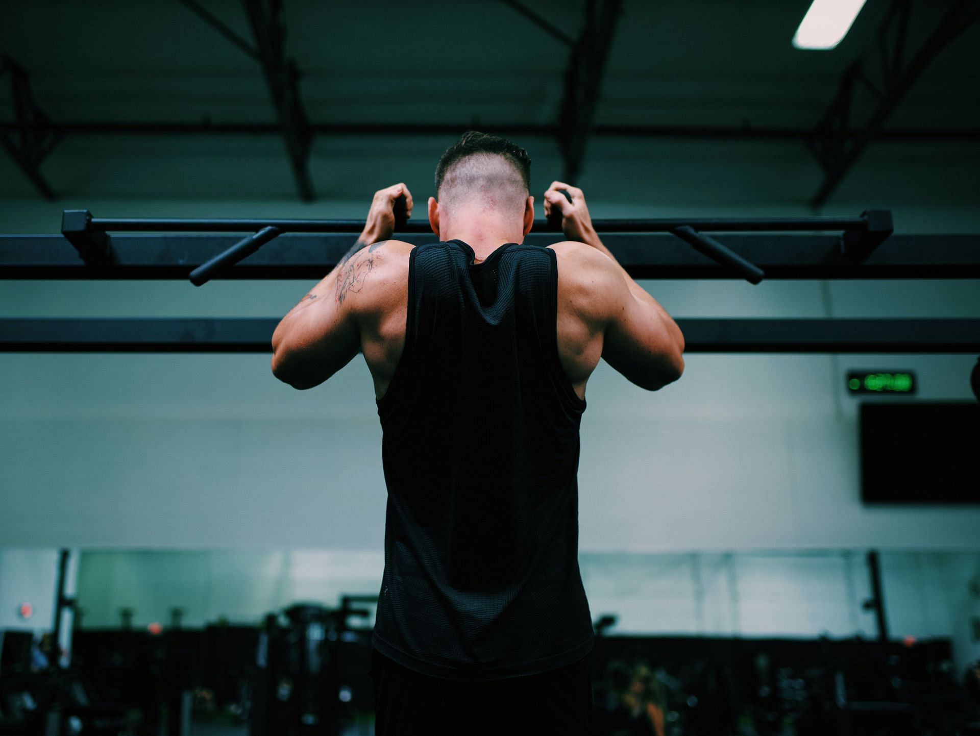 Pull-ups are a great asset for building back muscle. (Image via unsplash/Gordon Cowie)