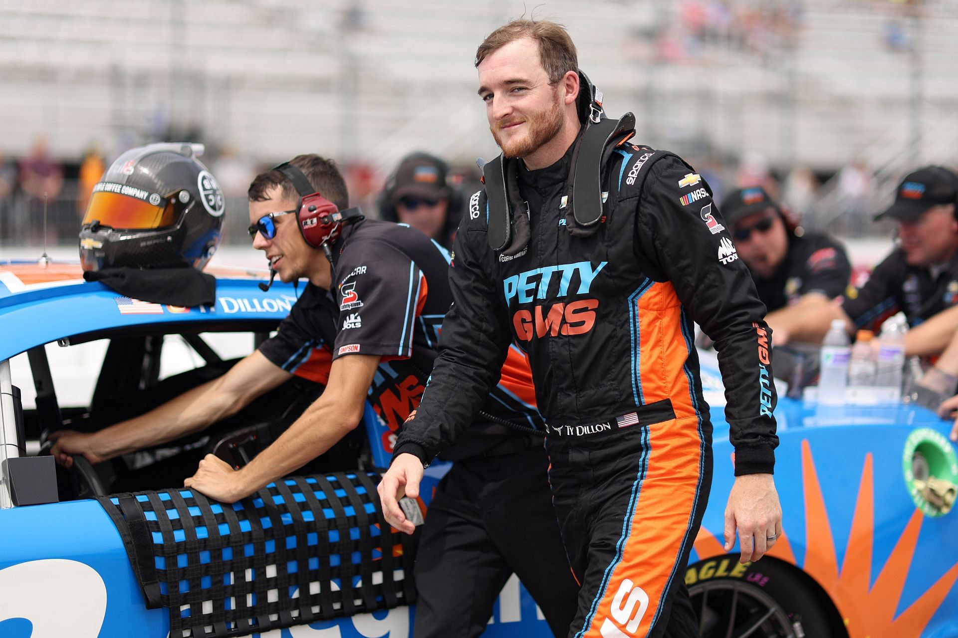 Ty Dillon and crew walk the grid during practice for the NASCAR Cup Series Ambetter 301 at New Hampshire Motor Speedway