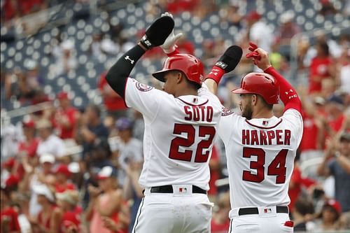 Bryce Harper and Juan Soto celebrate together after scoring back in 2018.