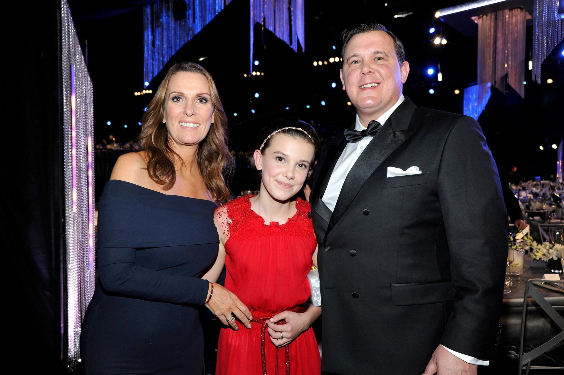 Millie Bobby Brown with her parents, Kelly and Robert Brown (Images via Getty)