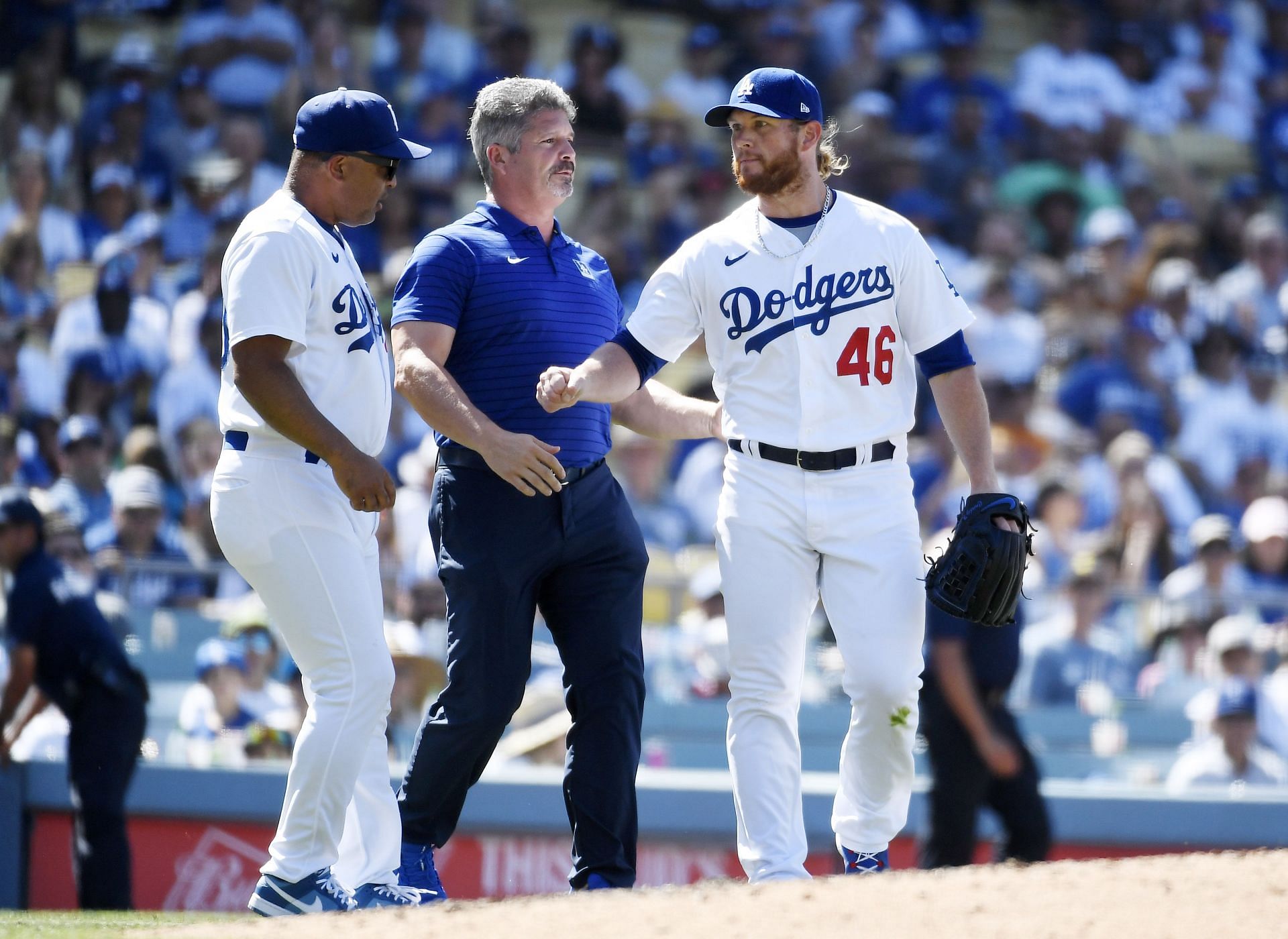 Los Angeles Dodgers closer Craig Kimbrel gets checked after being hit by a ball.