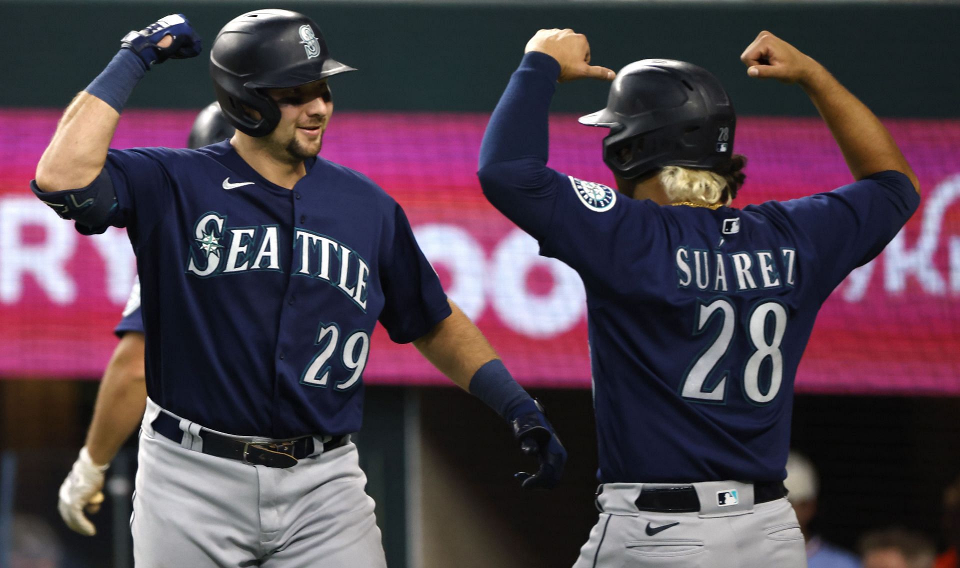 Cal Raleigh of the Seattle Mariners celebrates with teammate Eugenio Suarez