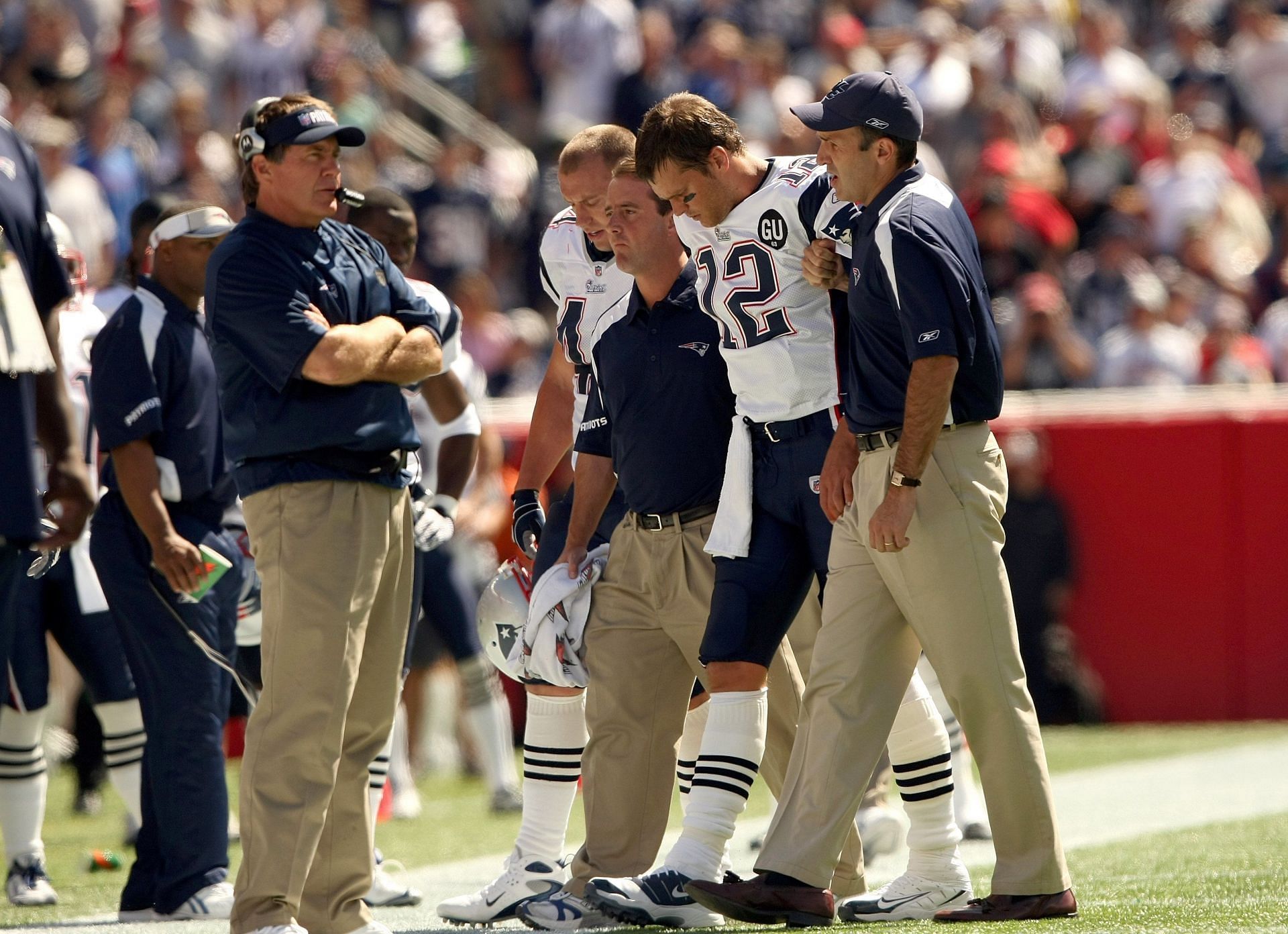 Tom Brady helped off the field following a knee injury