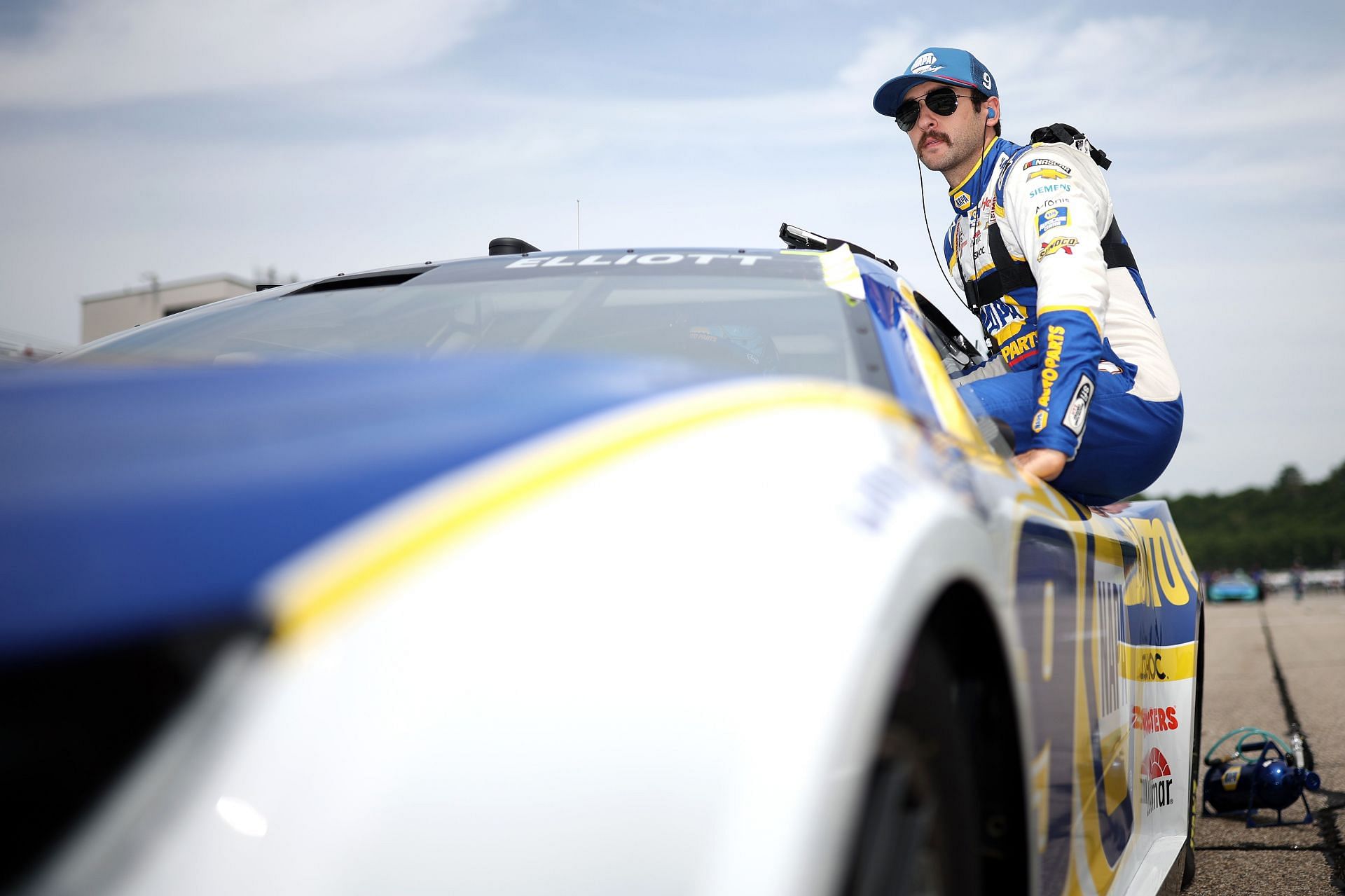 Chase Elliott enters his car during qualifying for the NASCAR Cup Series Ambetter 301 at New Hampshire Motor Speedway