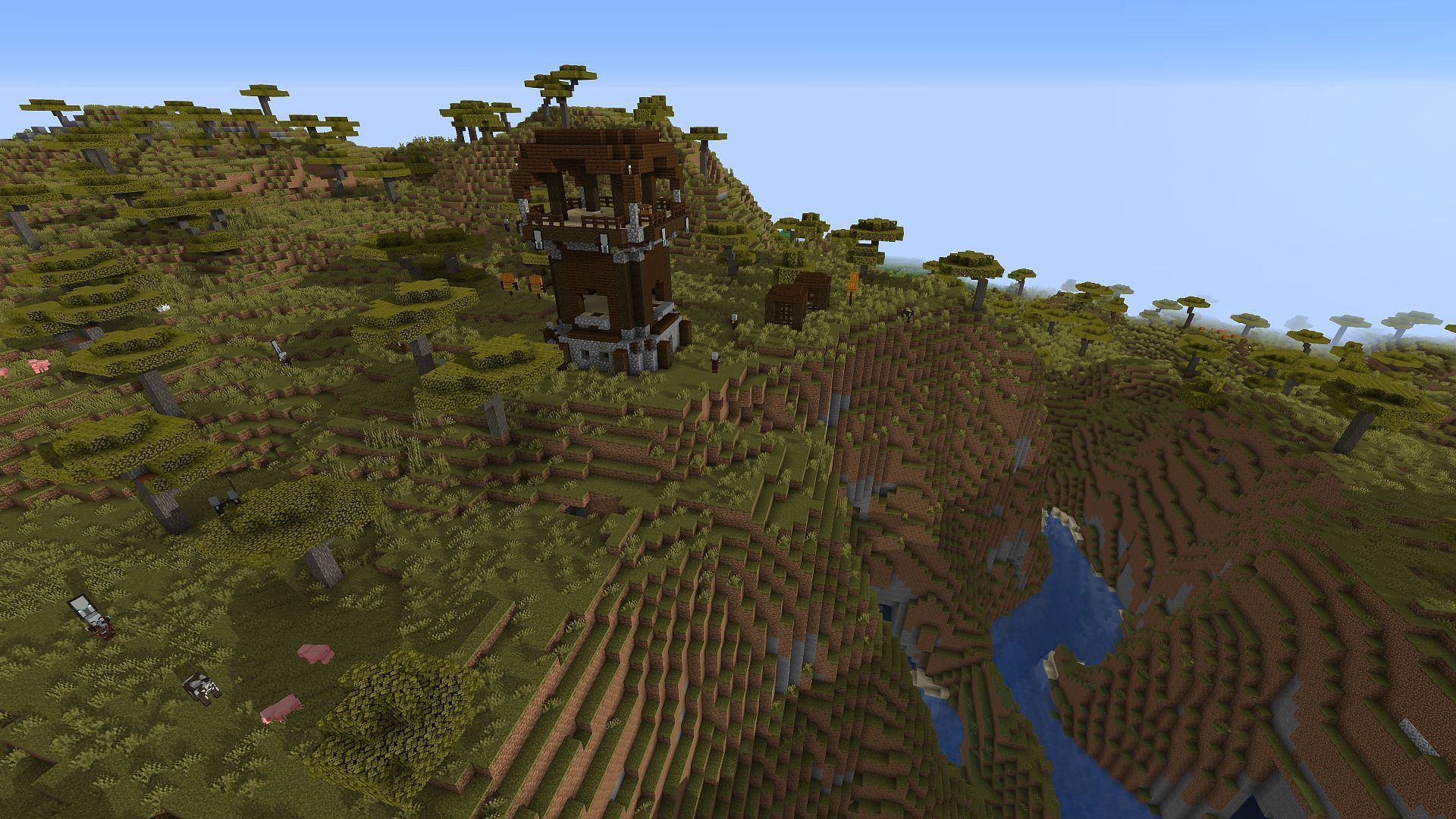 A pillager outpost on the edge of a canyon (Image via Minecraft)