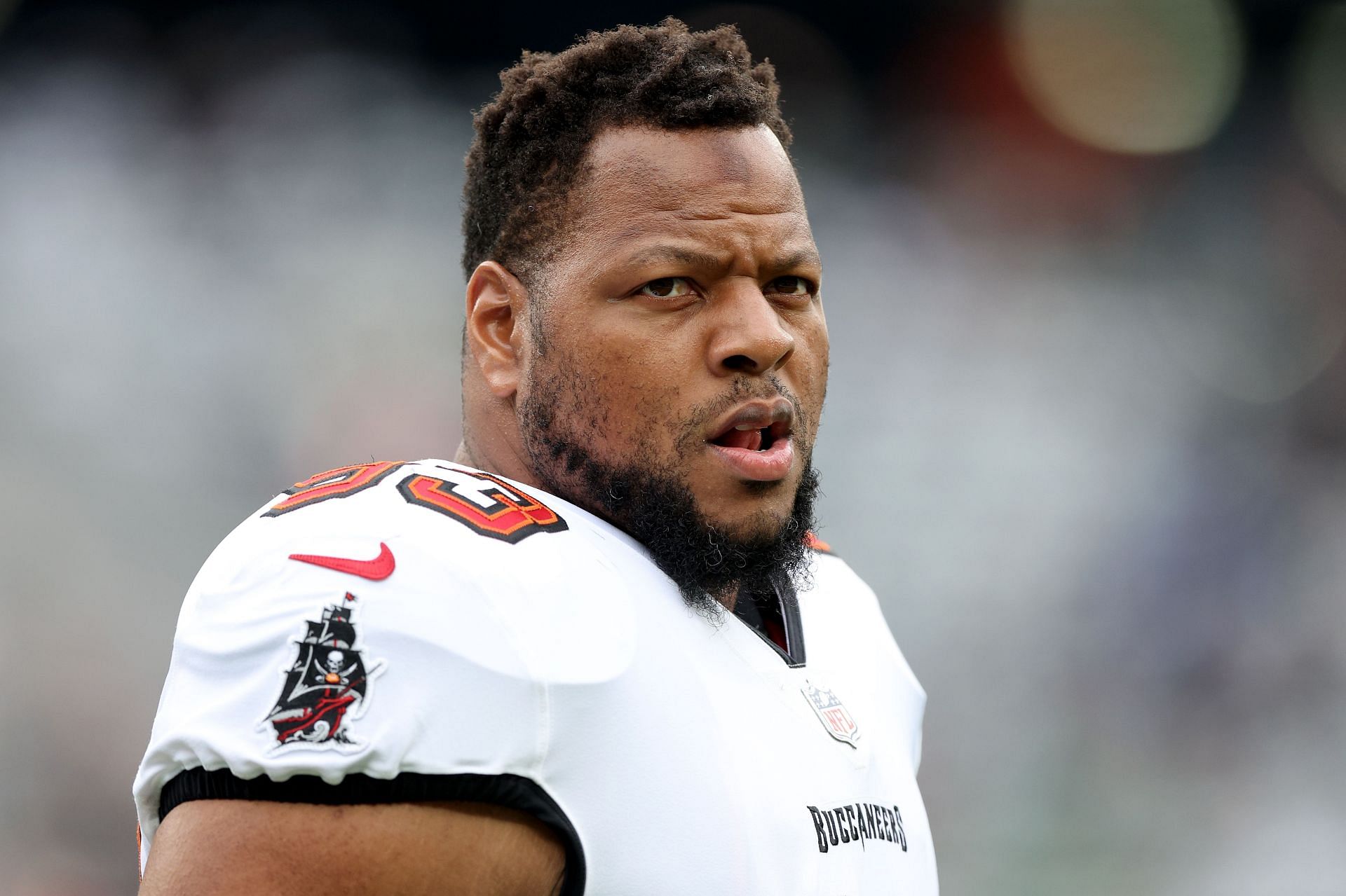 Former Tampa Bay Buccaneers defensive tackle Ndamukong Suh looks over the field