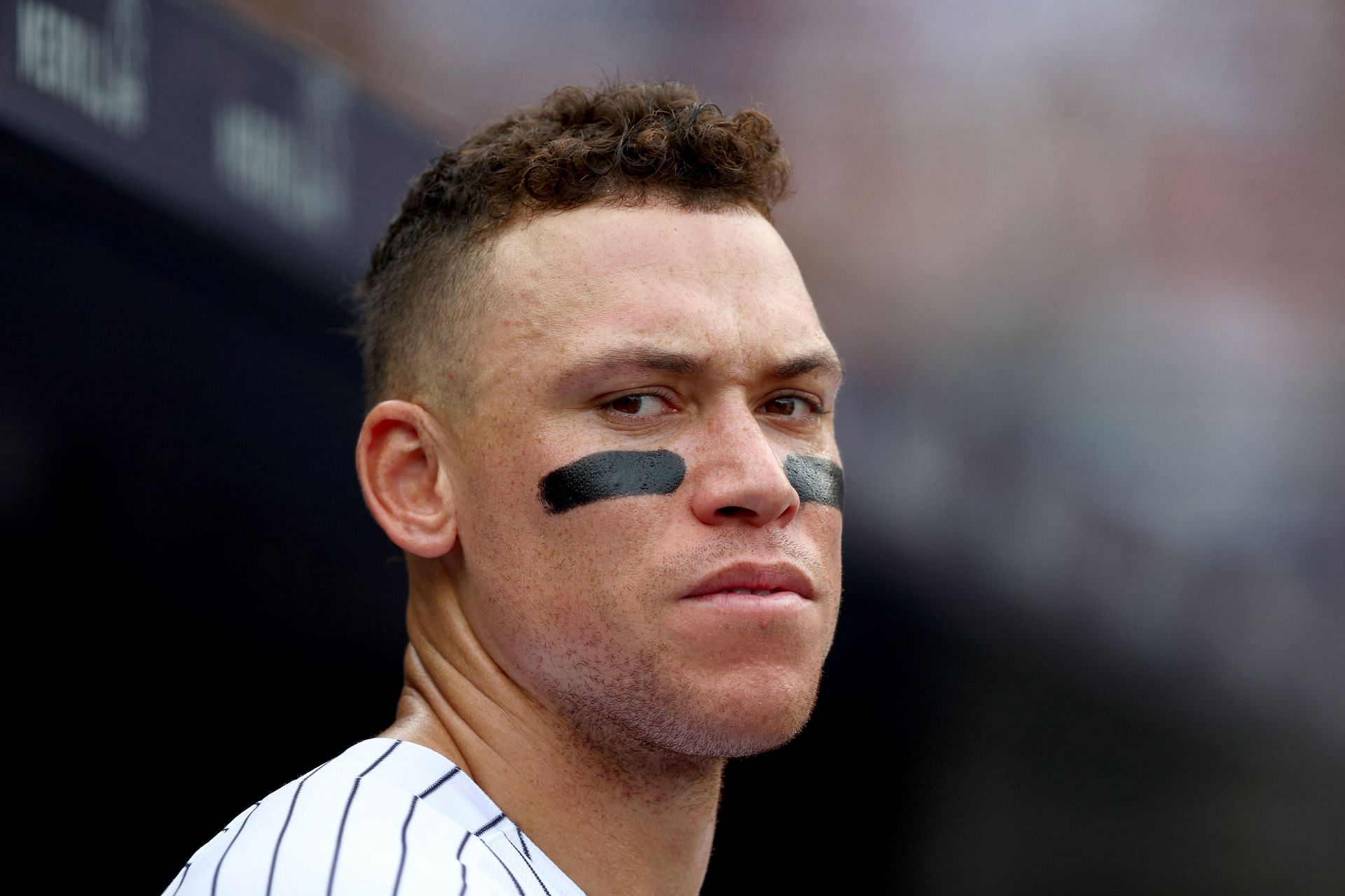 New York Yankees star Aaron Judge looks on from the dugout.