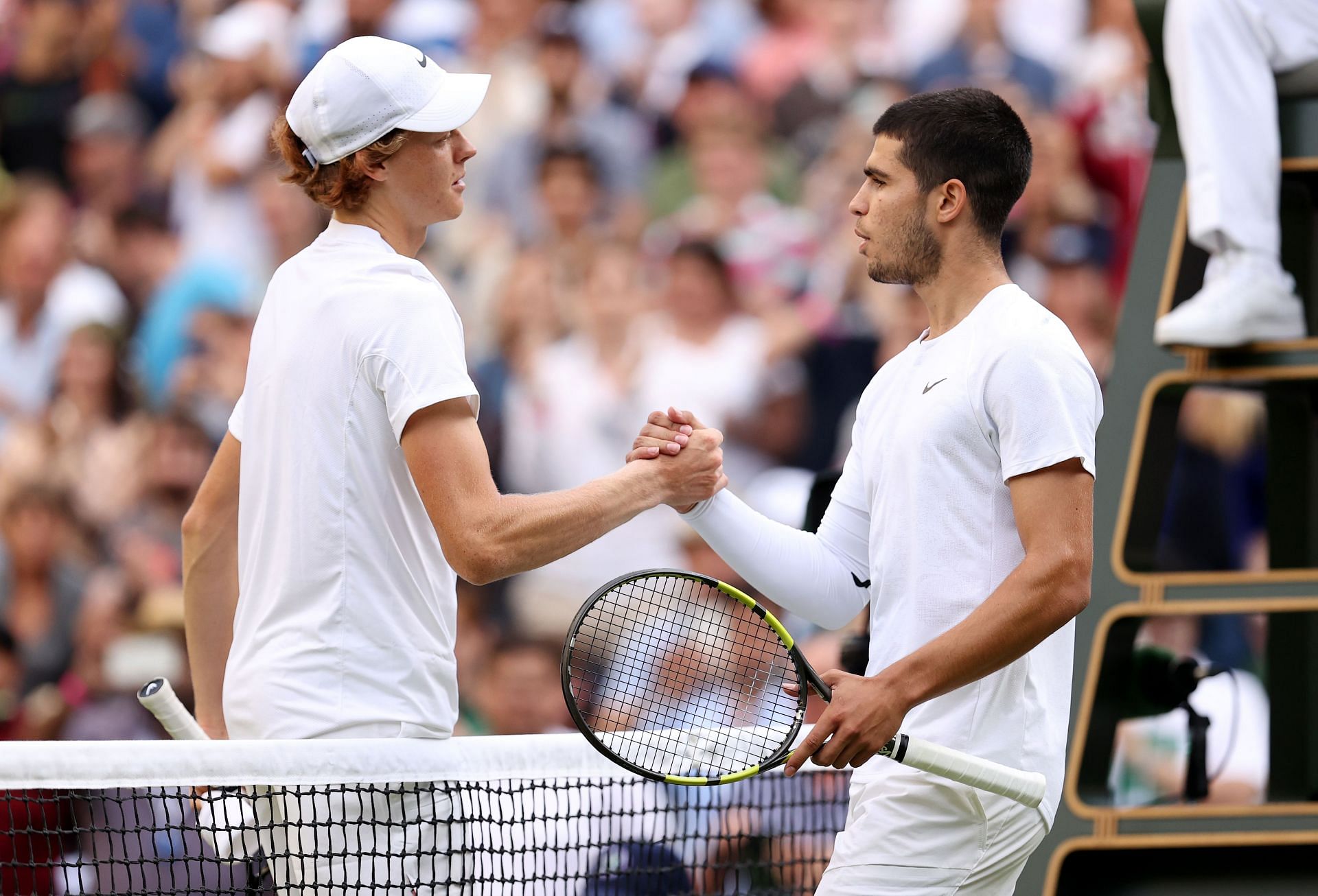 Jannik Sinner and Carlos Alcaraz shake hands at the net after their fourth-round battle at Wimbledon
