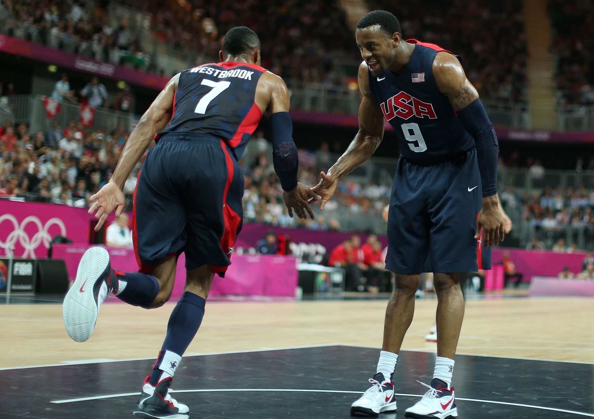 Russell Westbrook high-fives teammate Andre Iguodala of Team USA during the Preliminary Round of the 2012 London Olympic