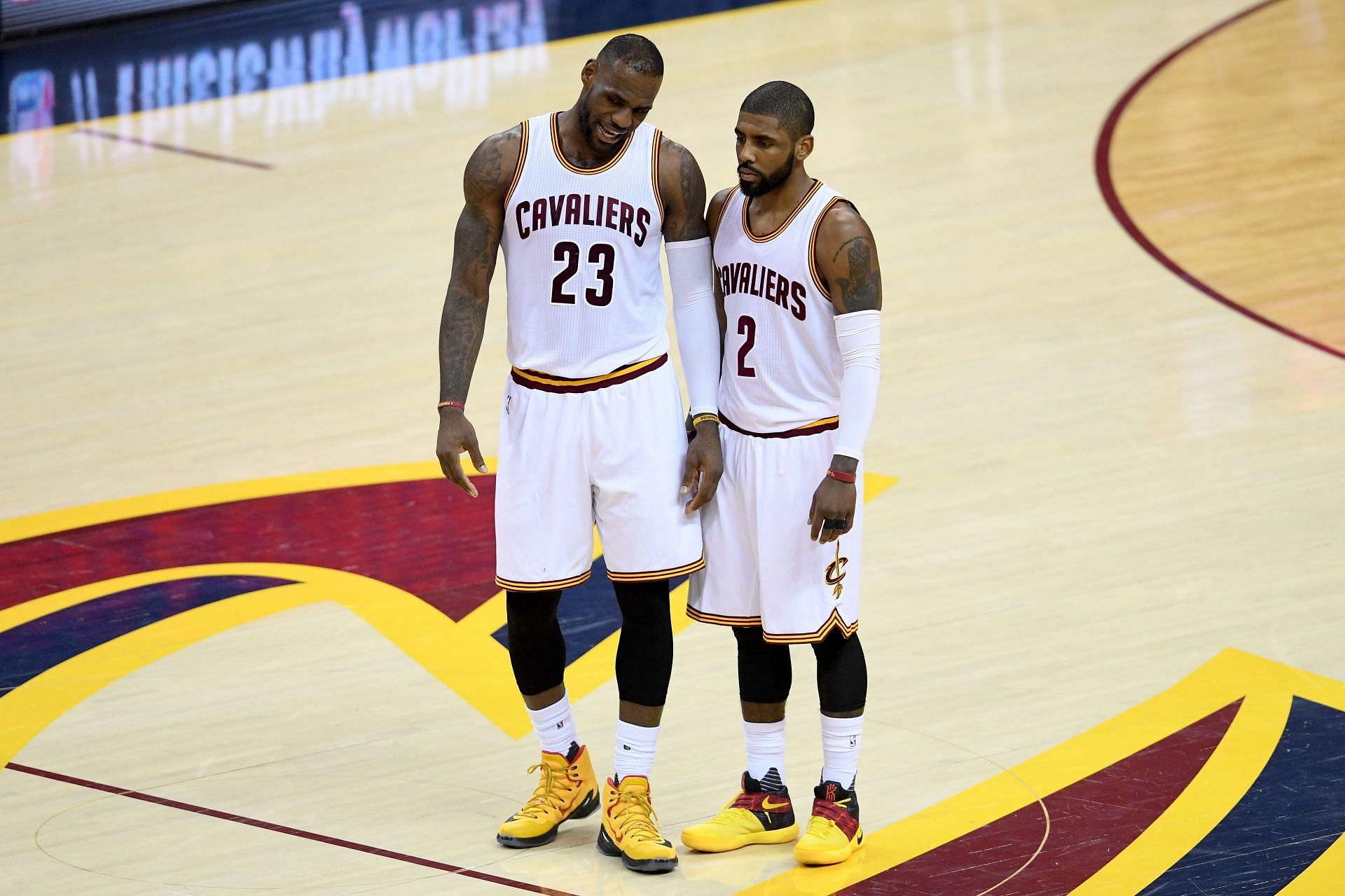 LeBron James #23 and Kyrie Irving #2 of the Cleveland Cavaliers talk at mid court in the first half against the Toronto Raptors in game one of the Eastern Conference Finals during the 2016 NBA Playoffs at Quicken Loans Arena on May 17, 2016 in Cleveland, Ohio.