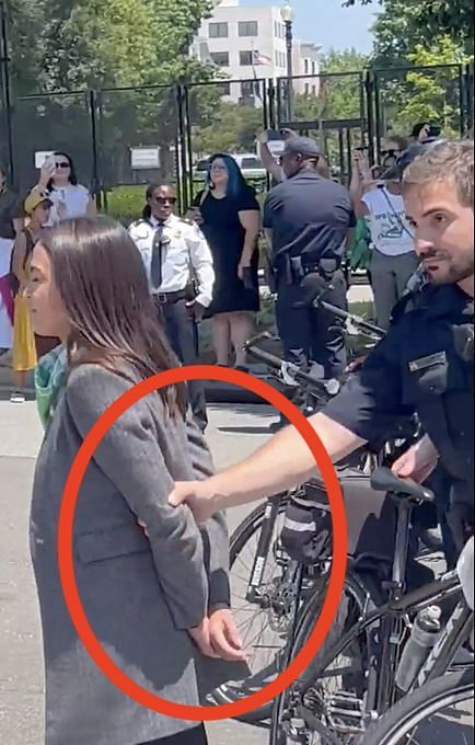 WATCH: Viral Video Of AOC Pretending To Be Handcuffed Sparks Online Debate