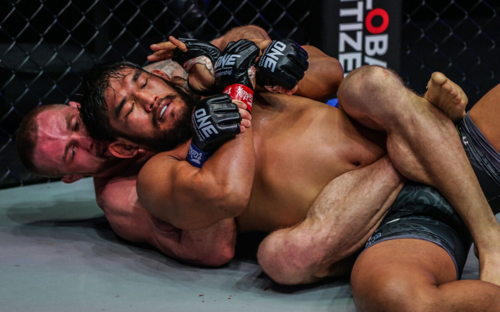 Vitaly Bigdash looks for a rear-naked choke against Aung La N Sang in their third match. [Photo ONE Championship]