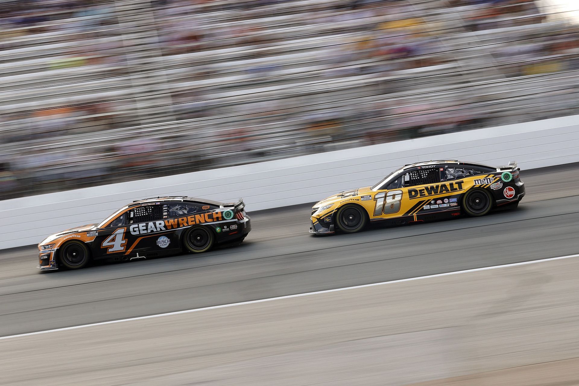 Kevin Harvick (#4 GEARWRENCH Ford) and Kyle Busch (#18 DeWalt Toyota) race during the 2022 NASCAR Cup Series Ambetter 301 at New Hampshire Motor Speedway in Loudon, New Hampshire (Photo by Tim Nwachukwu/Getty Images)