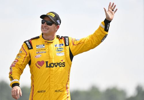 Michael McDowell waves to fans onstage during driver intros prior to the NASCAR Cup Series Ally 400 at Nashville Superspeedway