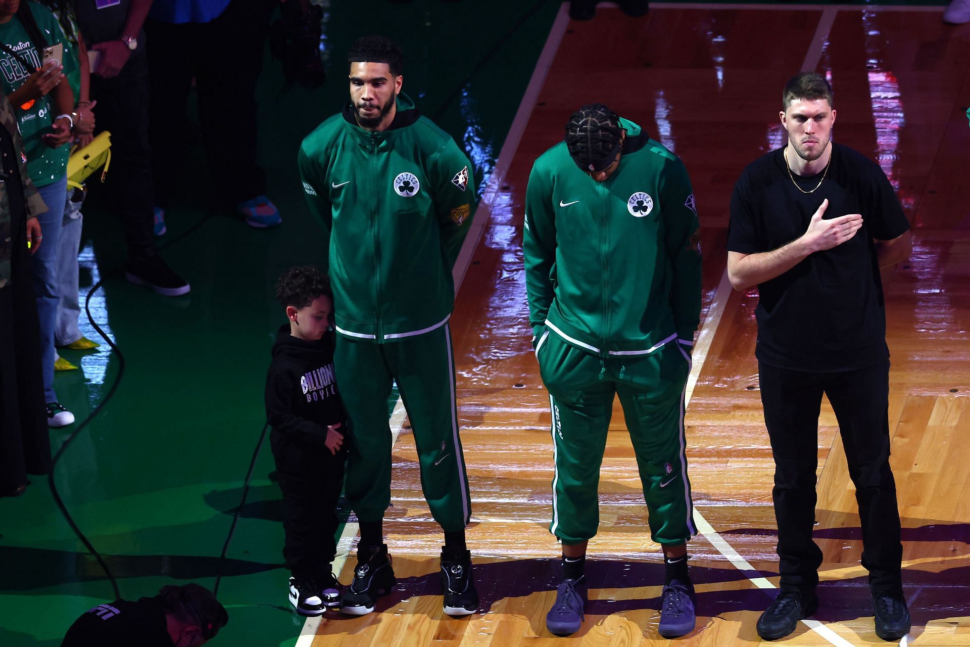 Juwan Morgan and Sam Hauser of the Boston Celtics next to Jayson Tatum and his son, Deuce