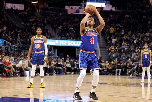 Jonathan Kuminga (00), Moses Moody (4) and Jordan Poole of the Golden State Warriors