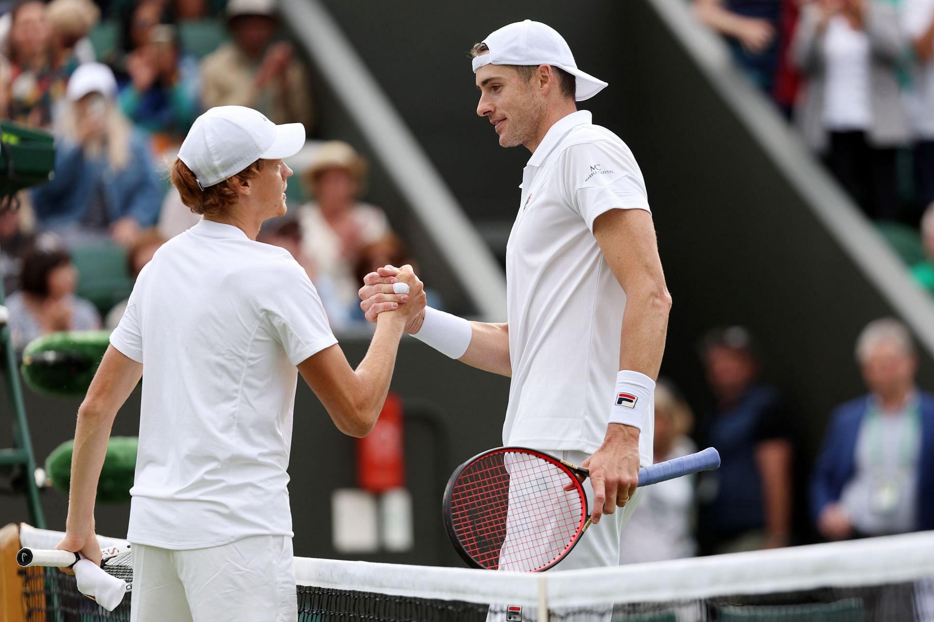 Jannik Sinner and John Isner after their encounter at the 2022 Wimbledon Championships