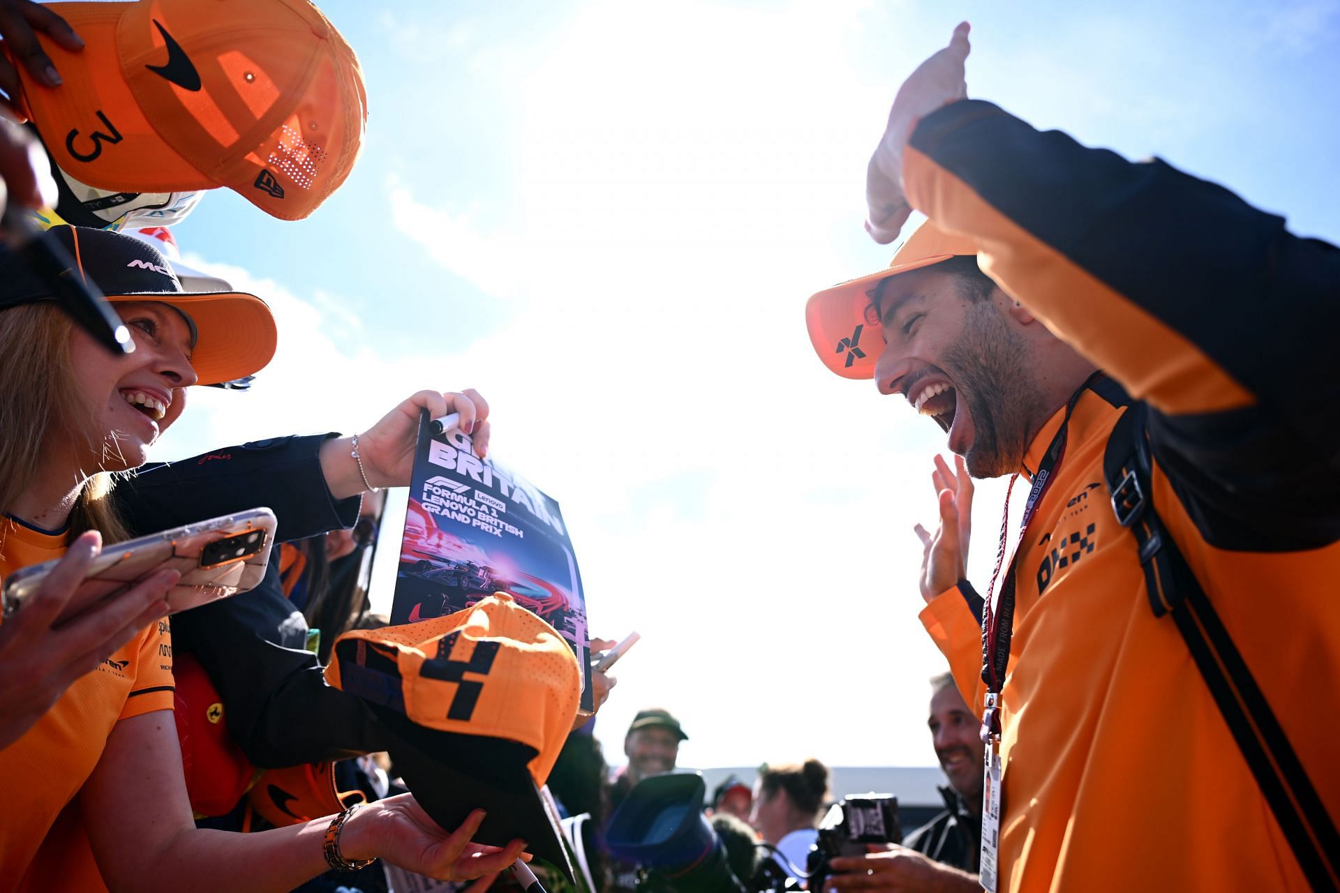 Daniel Ricciardo takes pictures with fans before entering the paddock during the 2022 F1 British GP (Photo by Clive Mason/Getty Images)