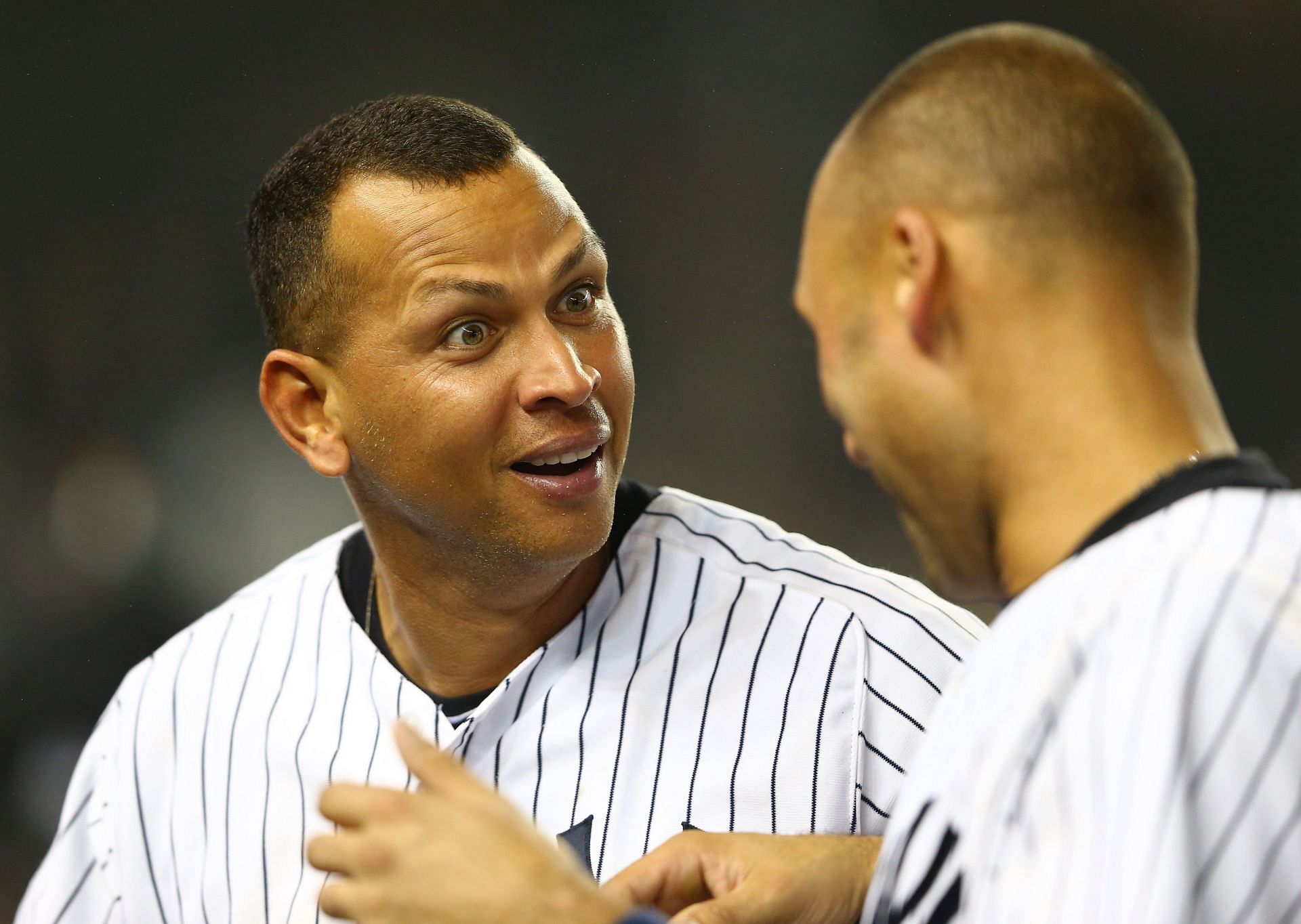 A-Rod and Jeter interact during a Boston Red Sox v New York Yankees game.