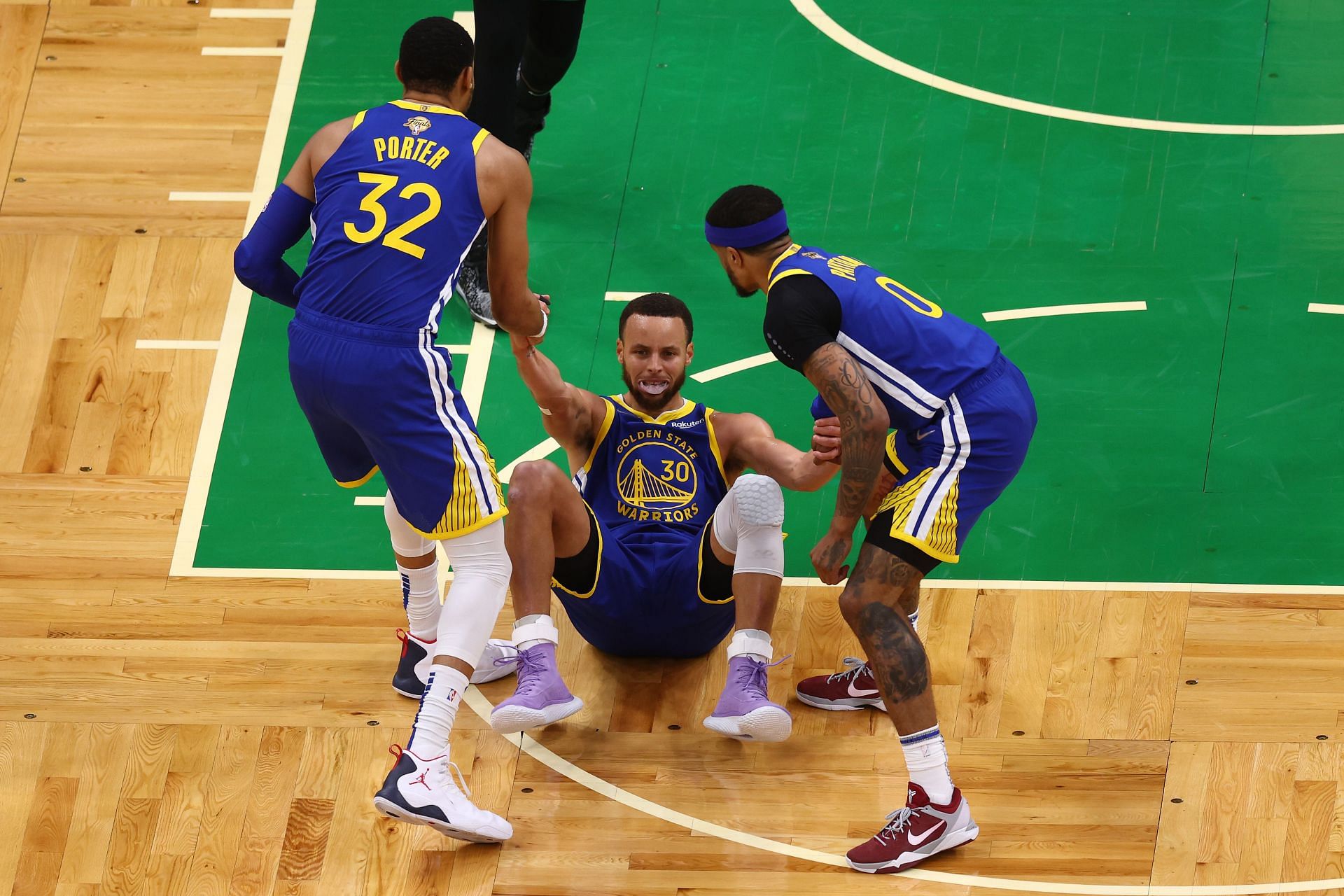 Otto Porter Jr., Steph Curry and Gary Payton II of the Golden State Warriors