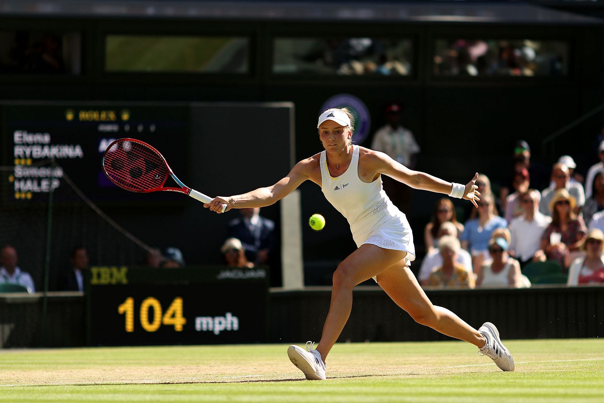 Elena Rybakina stretches to reach the ball during her semifinal match at the 2022 Wimbledon Championships