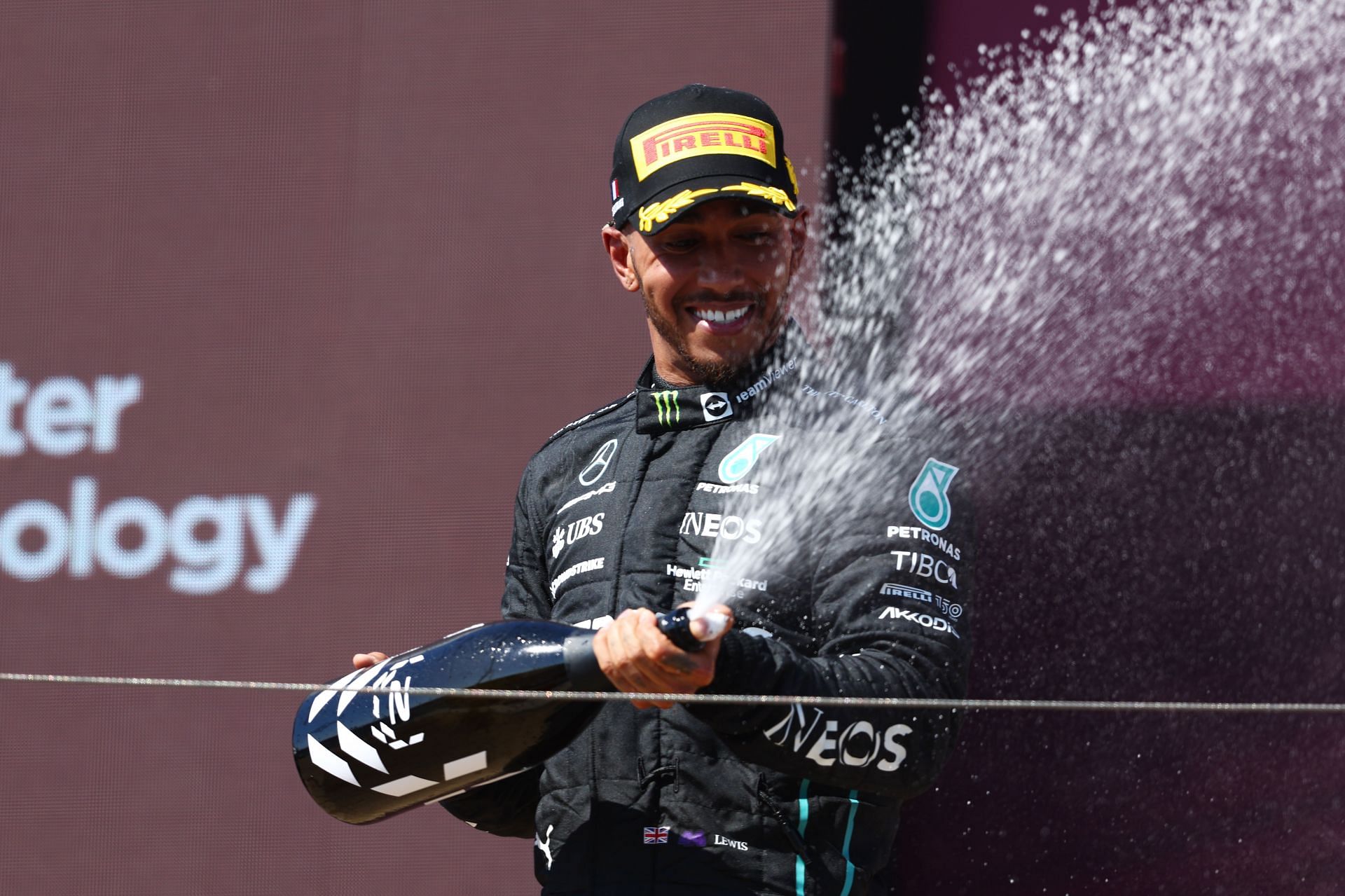 Mercedes driver Lewis Hamilton sprays champagne on the podium after claiming P2 at the 2022 F1 French GP. (Photo by Clive Rose/Getty Images)
