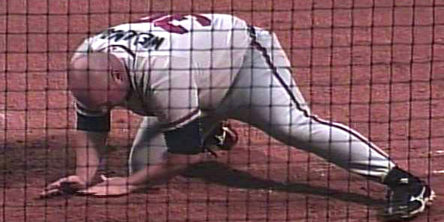 Mississippi Braves manager Phil Wellman throwing dirt on home plate